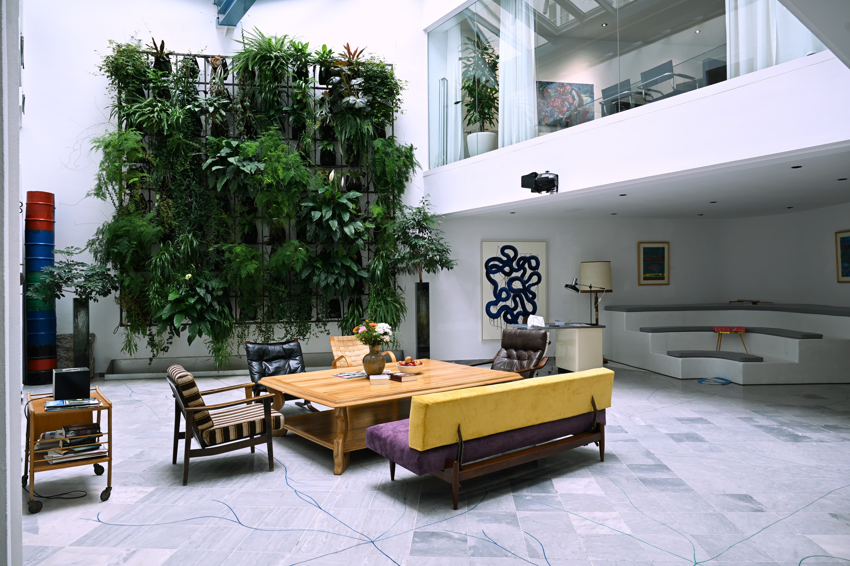 A refined lounge accented by a striking vertical garden centerpiece.