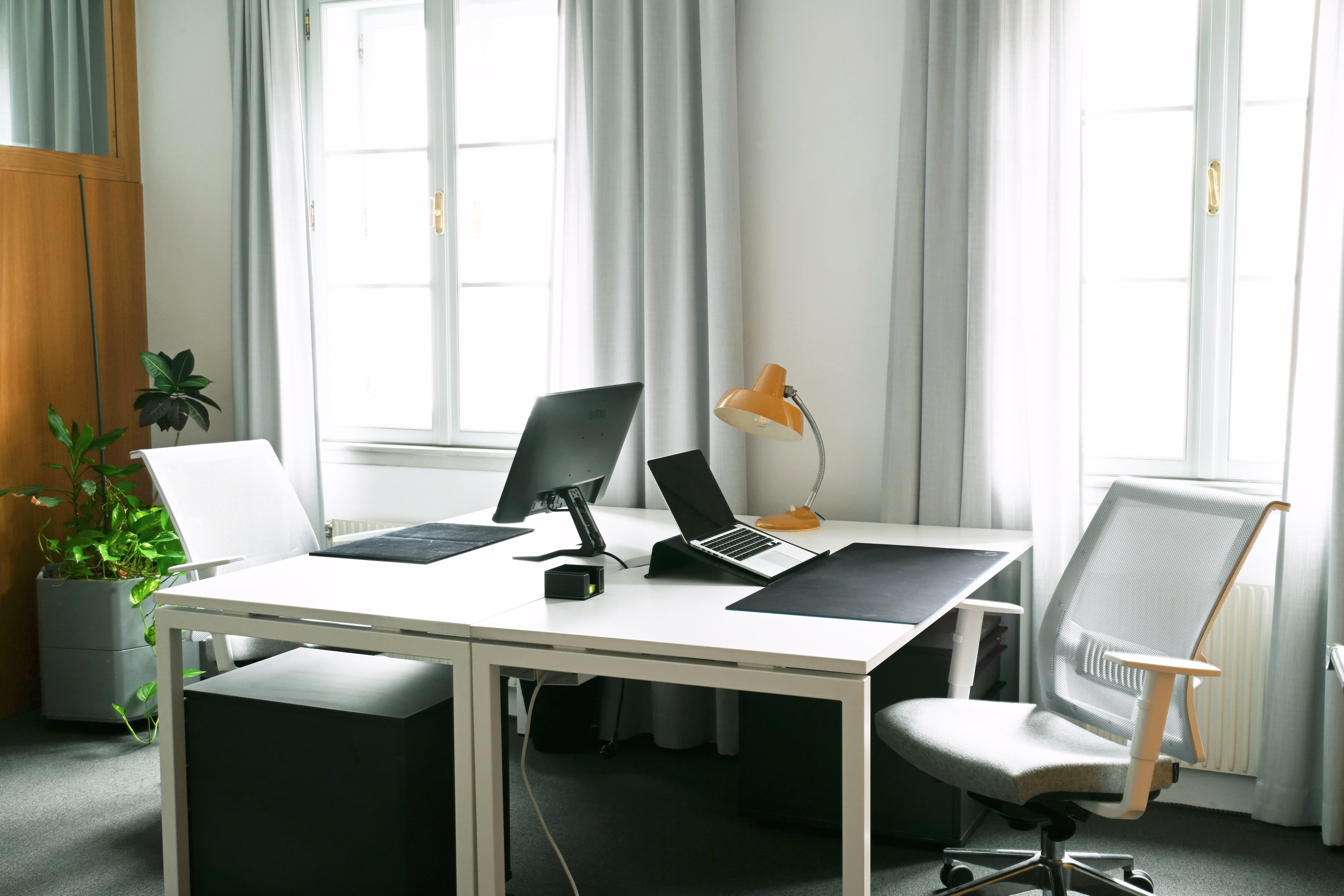 A quiet private office with generous natural light.