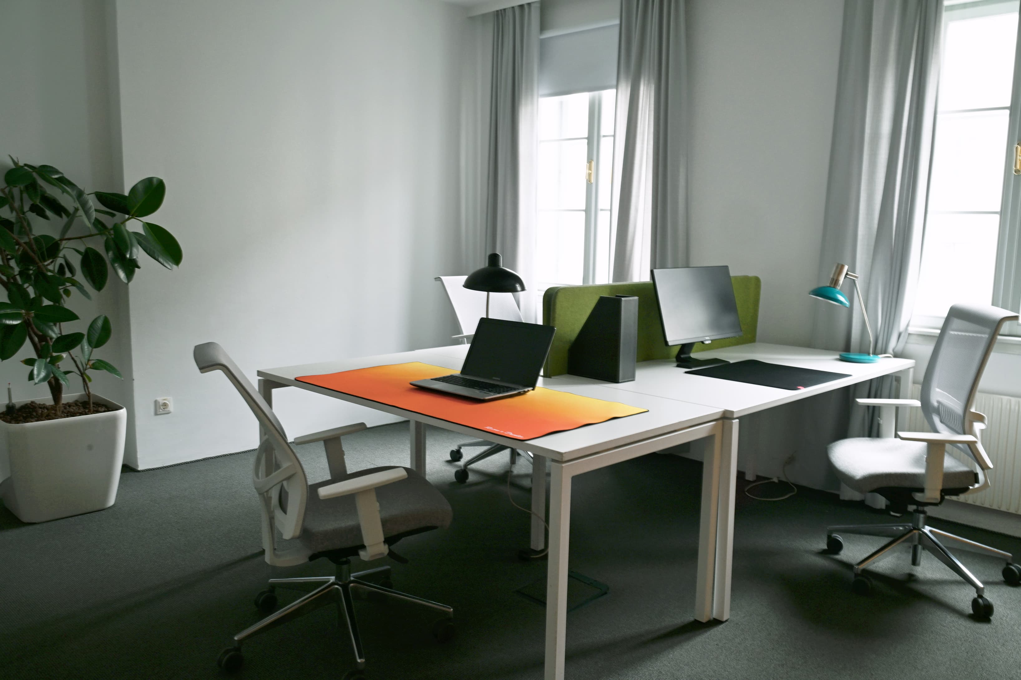 A refined private office with a contemporary layout and abundant natural light.