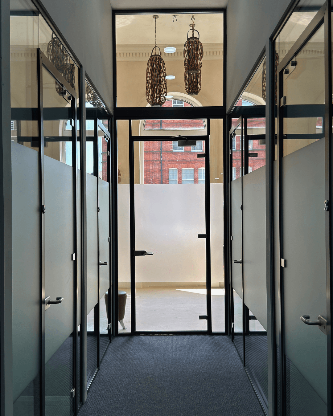 Glass-partitioned private rooms at SSV Suites, 106 Finchley Road NW3. Studio rooms to rent, North London.