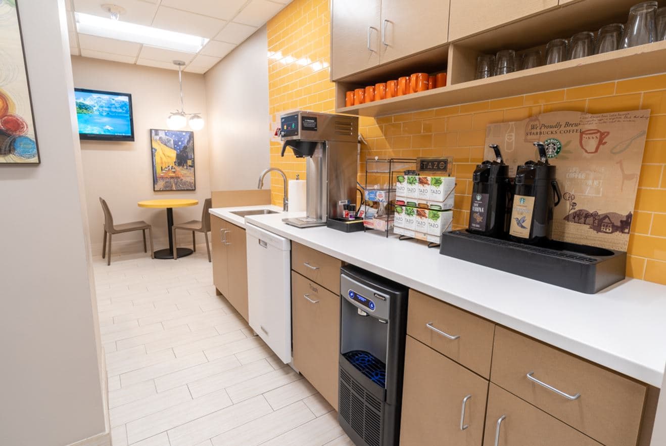 Shared spaces including kitchen, coworking, meeting rooms, copy stations