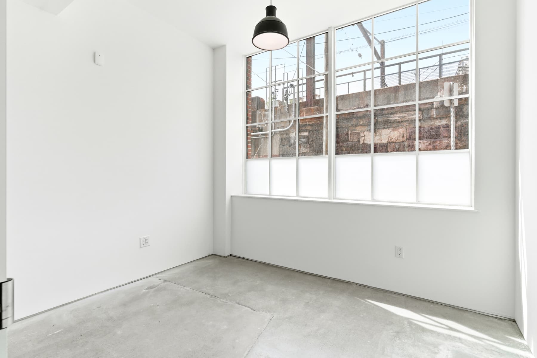 Bright 12x12 office with oversized industrial windows. Desk and chair included. Bright 12x12 office with oversized industrial windows. Desk and chair included.