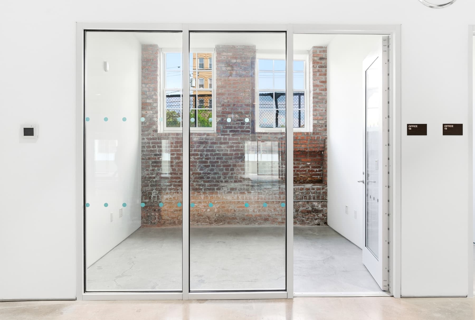 10x11 private office with brick accent wall. Desk and chair included. 10x11 private office with brick accent wall. Desk and chair included.