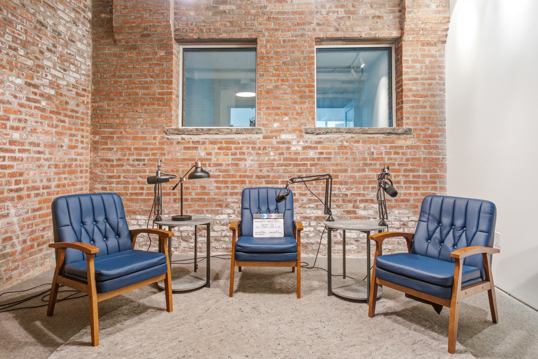 Podcast room with mics and seating. Podcast room with mics and seating.