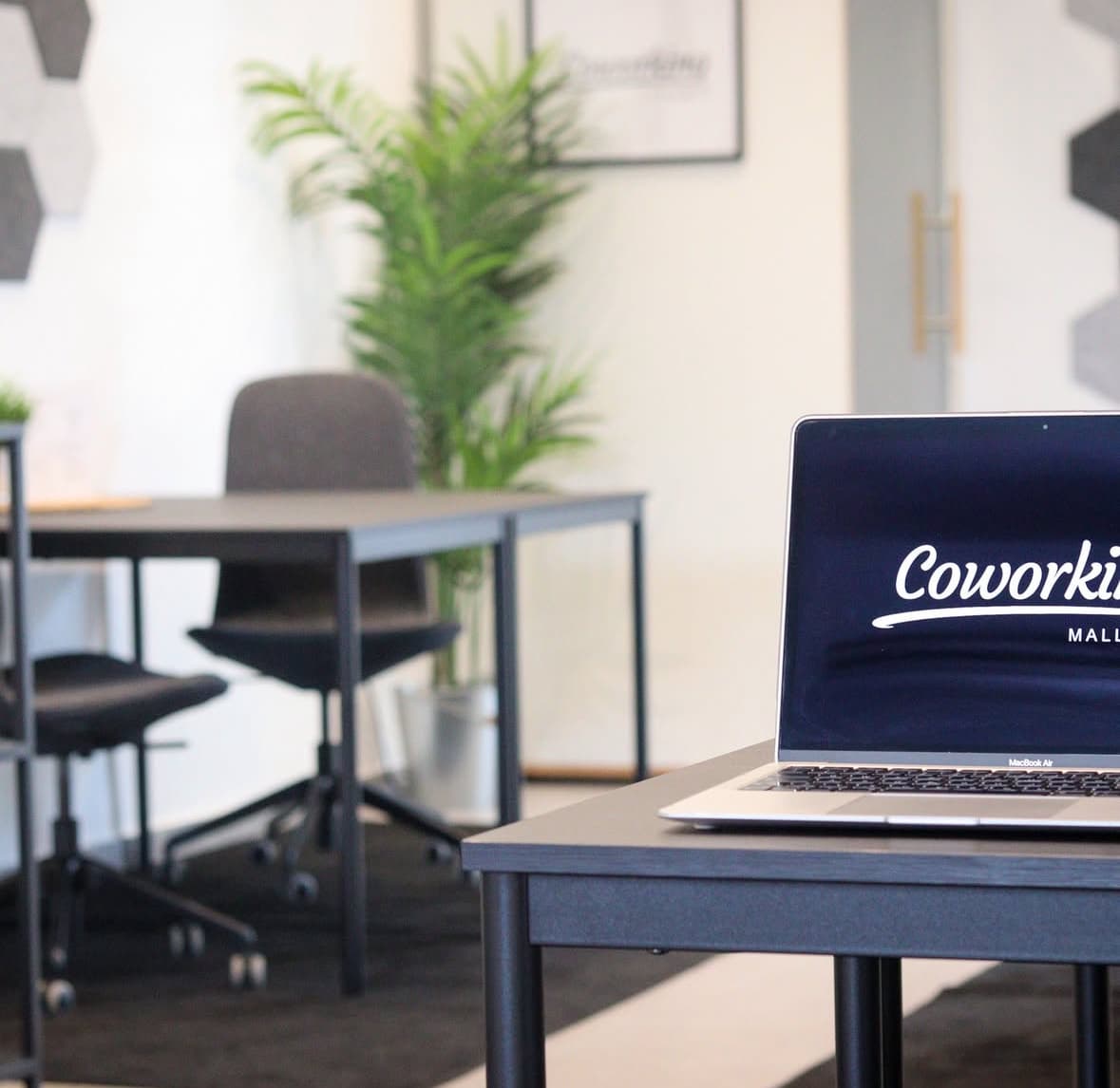 Focused workspace with laptop and branded Coworking Mallorca setup
