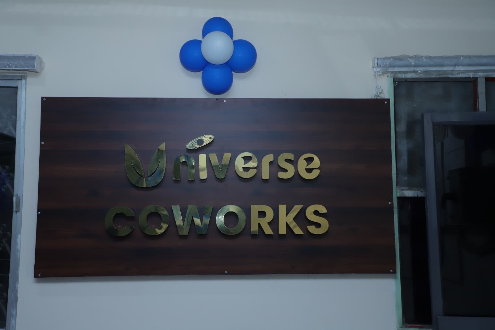 Premium Universe Coworks signboard at our Trichy location — gold lettering on rich wood panel, marking Trichy's most professi Premium Universe Coworks signboard at our Trichy location — gold lettering on rich wood panel, marking Trichy's most professi
