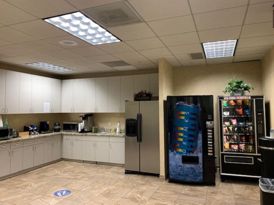 Community Kitchen stocked with plates, utensils, cups, and plenty of tea and coffee