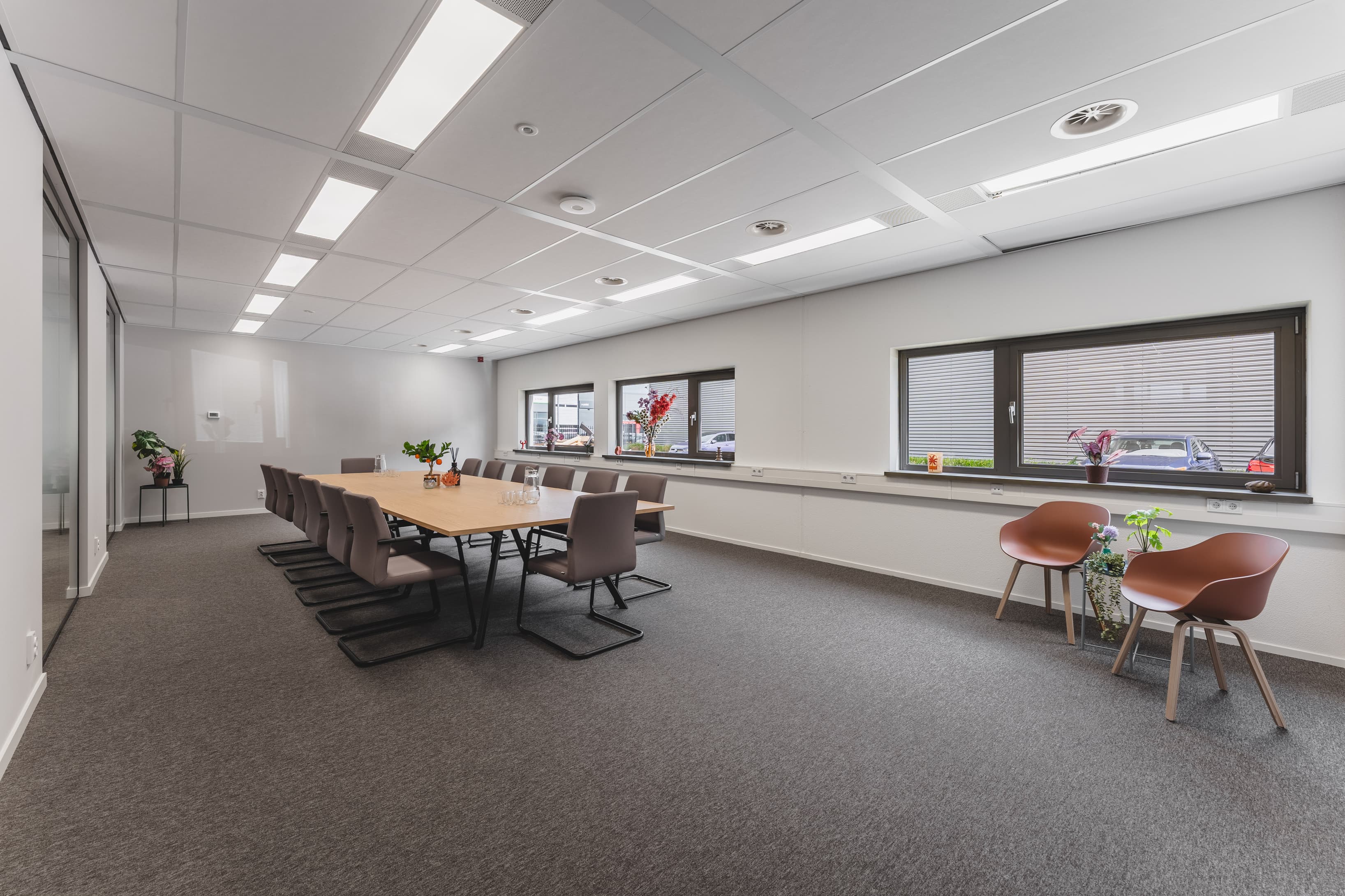 Spacious meeting room at Nexpace Almere with a large conference table and comfortable seating Spacious meeting room at Nexpace Almere with a large conference table and comfortable seating