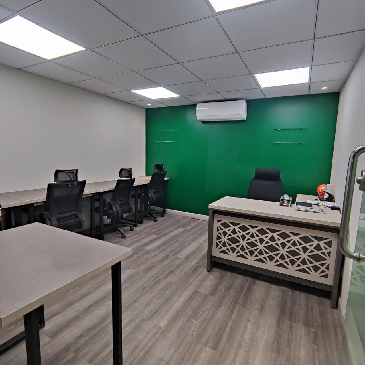 A private 6-desk office with an executive-style workstation, ideal for guided team operations. A private 6-desk office with an executive-style workstation, ideal for guided team operations.