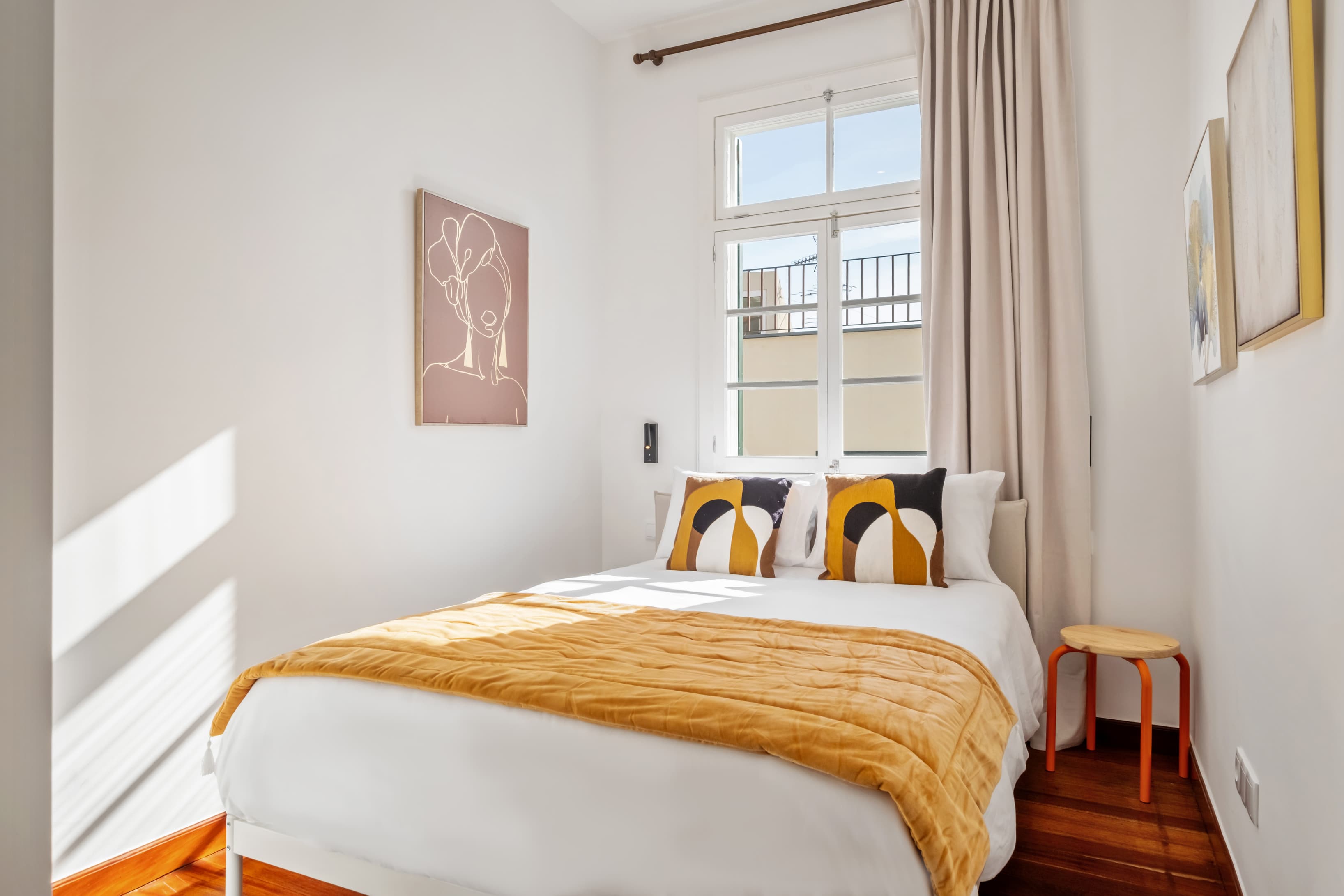 Cozy private room flooded with natural light, featuring comfortable bedding and minimalist decor.