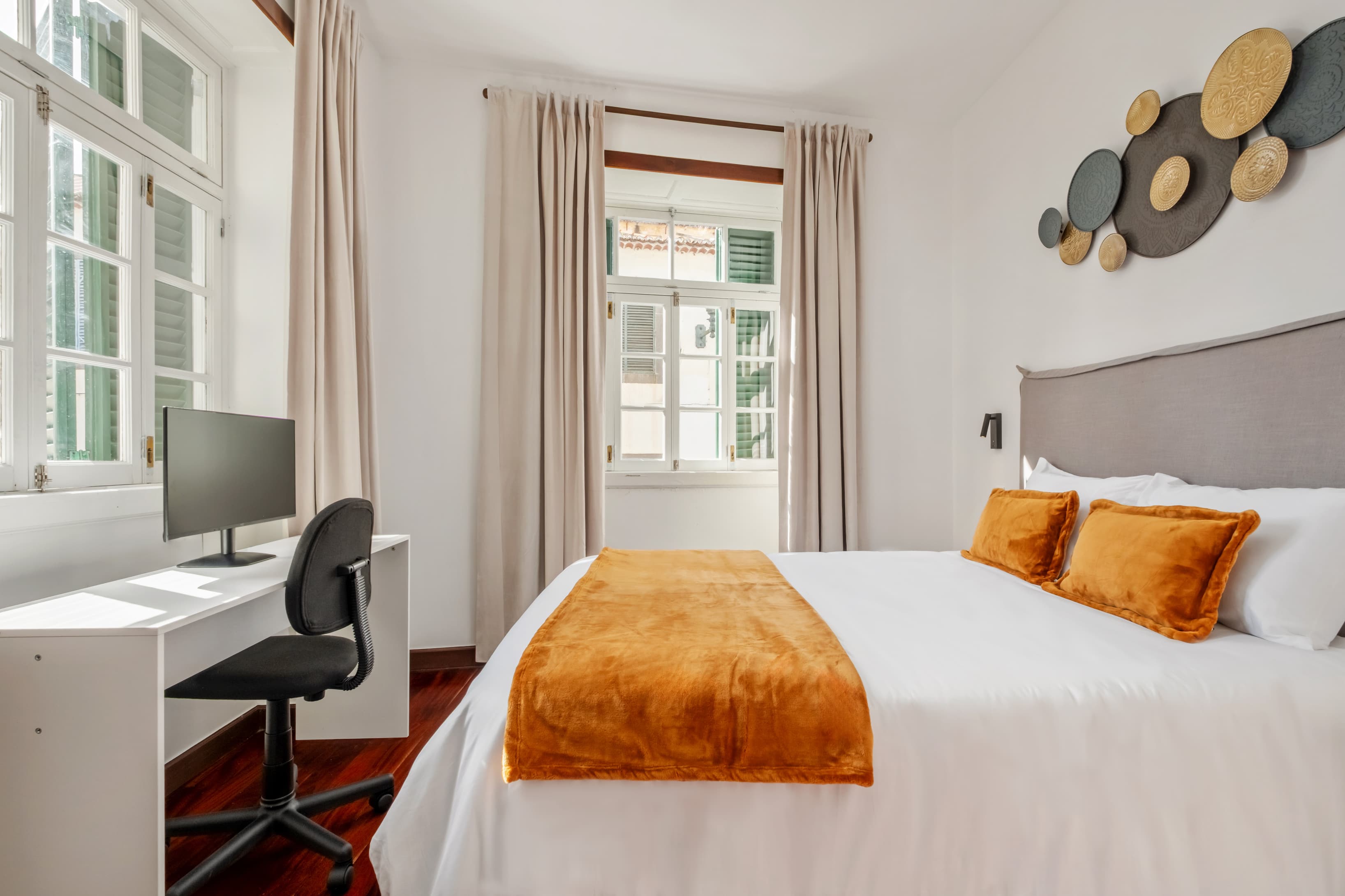 Private bedroom equipped with a dedicated workspace, including a desk and ergonomic chair for focused remote work.