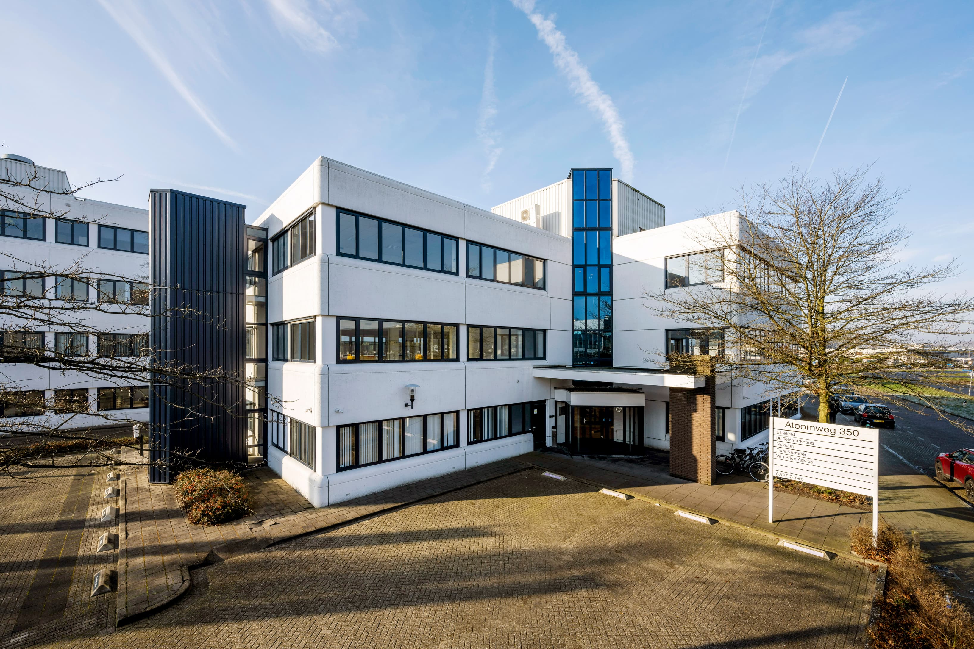 Exterior view of Atoomweg 350 in Utrecht, featuring a professional office building with an on-site park