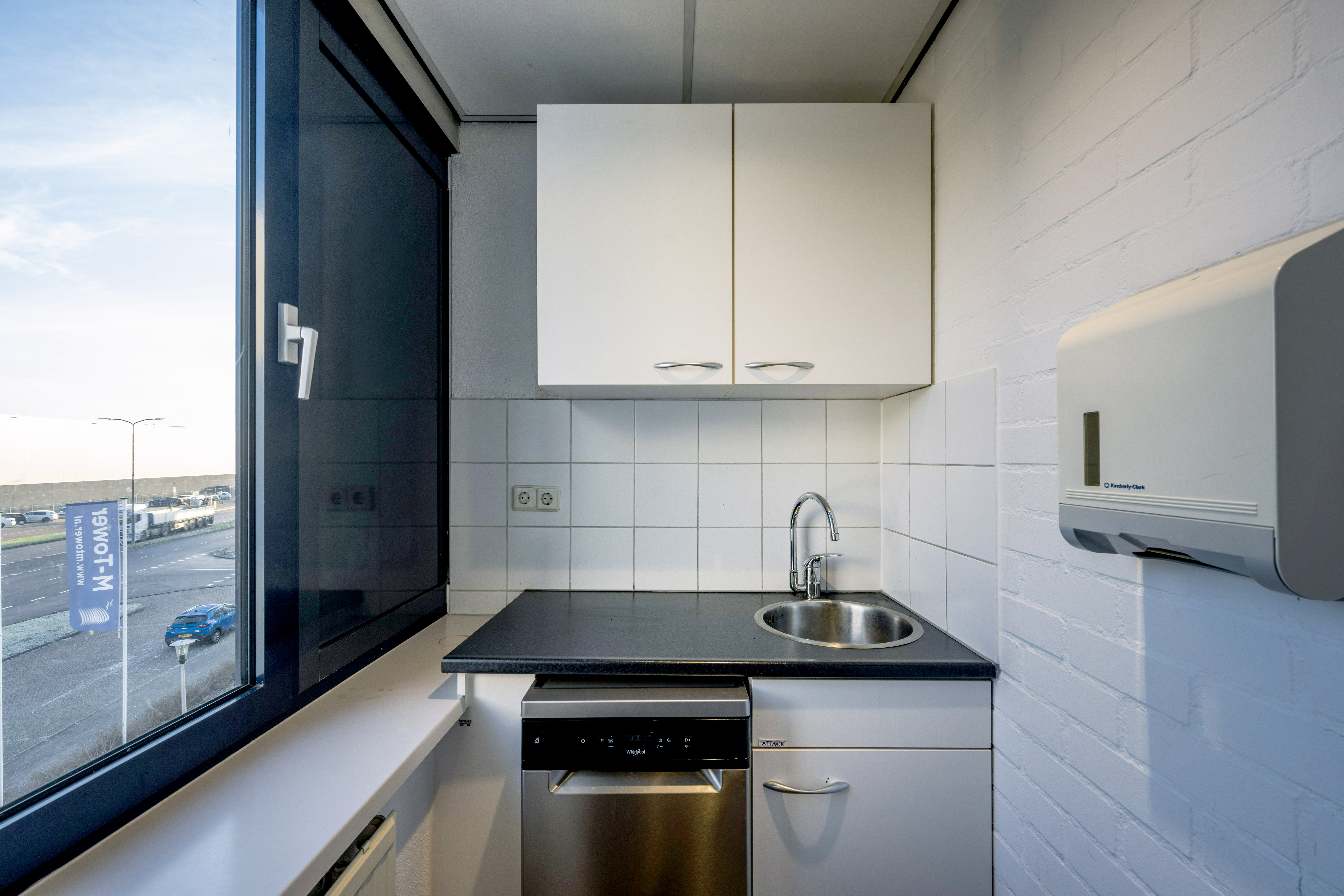 Kitchenette with sink, storage and dishwasher, overlooking the surrounding business area