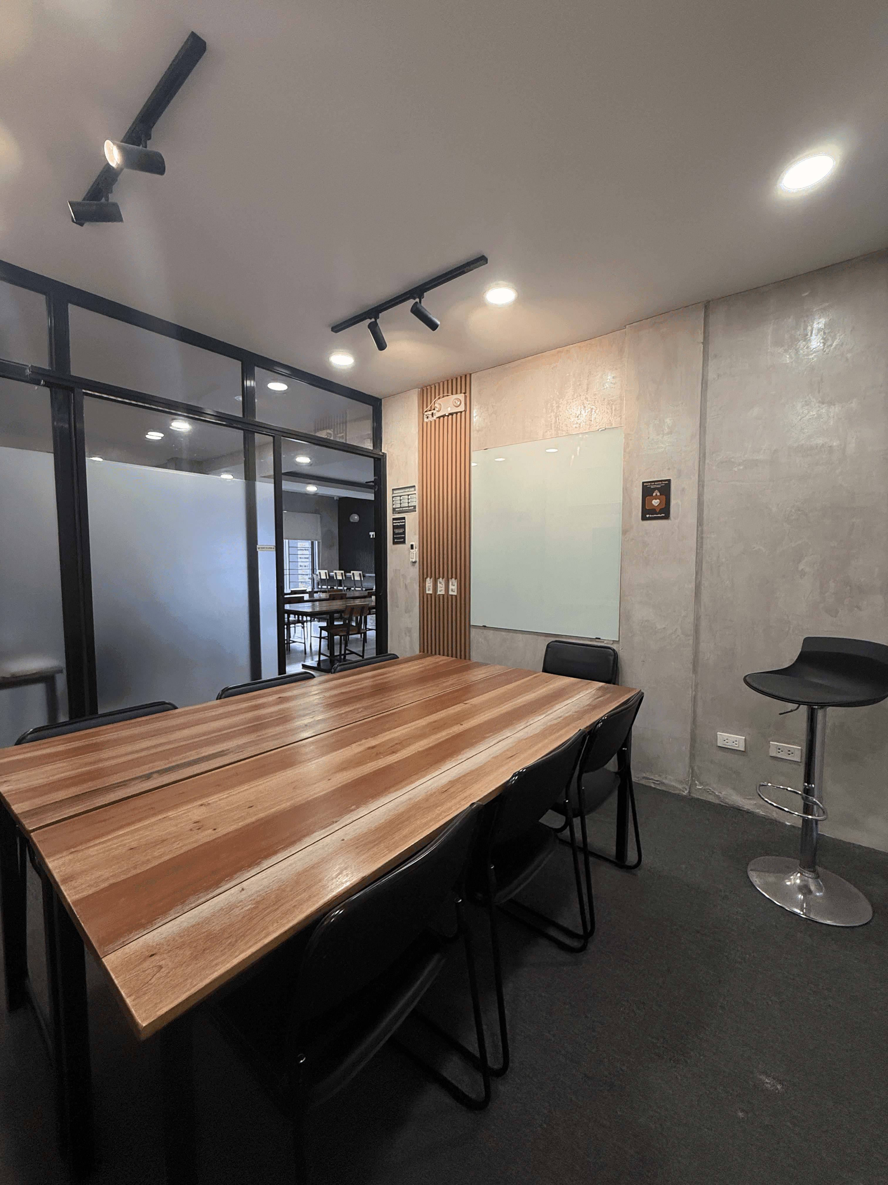 Meeting Room - Spacious table seating and a wall-mounted writing board for brainstorming and planning. Meeting Room - Spacious table seating and a wall-mounted writing board for brainstorming and planning.