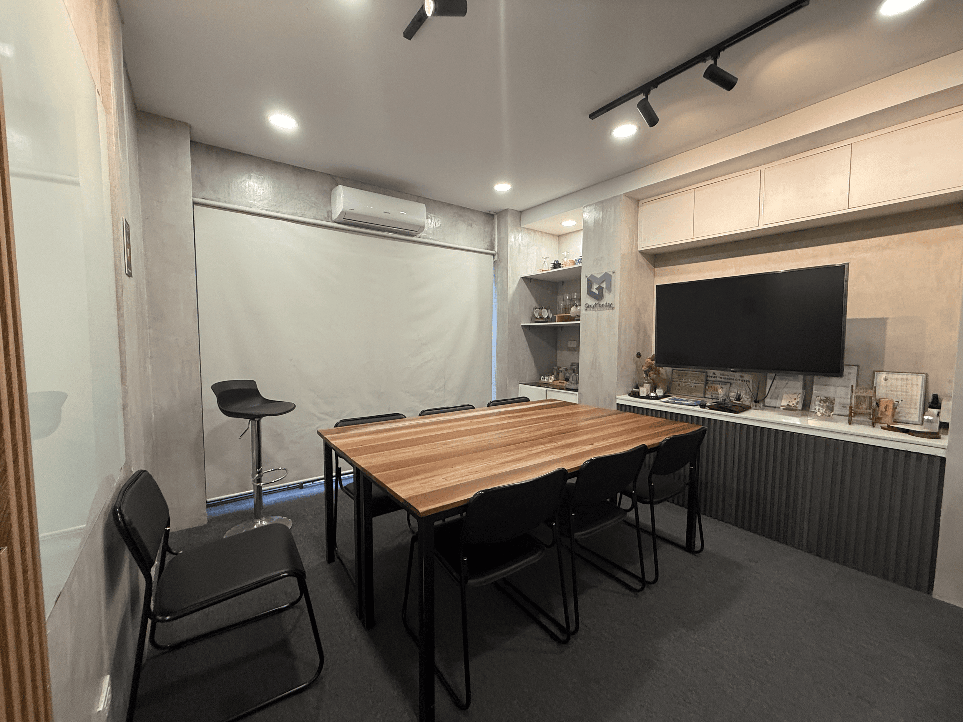 Full Meeting Room - A private, air-conditioned meeting room with a wide table, cushioned chairs, and a presentation monitor. Full Meeting Room - A private, air-conditioned meeting room with a wide table, cushioned chairs, and a presentation monitor.