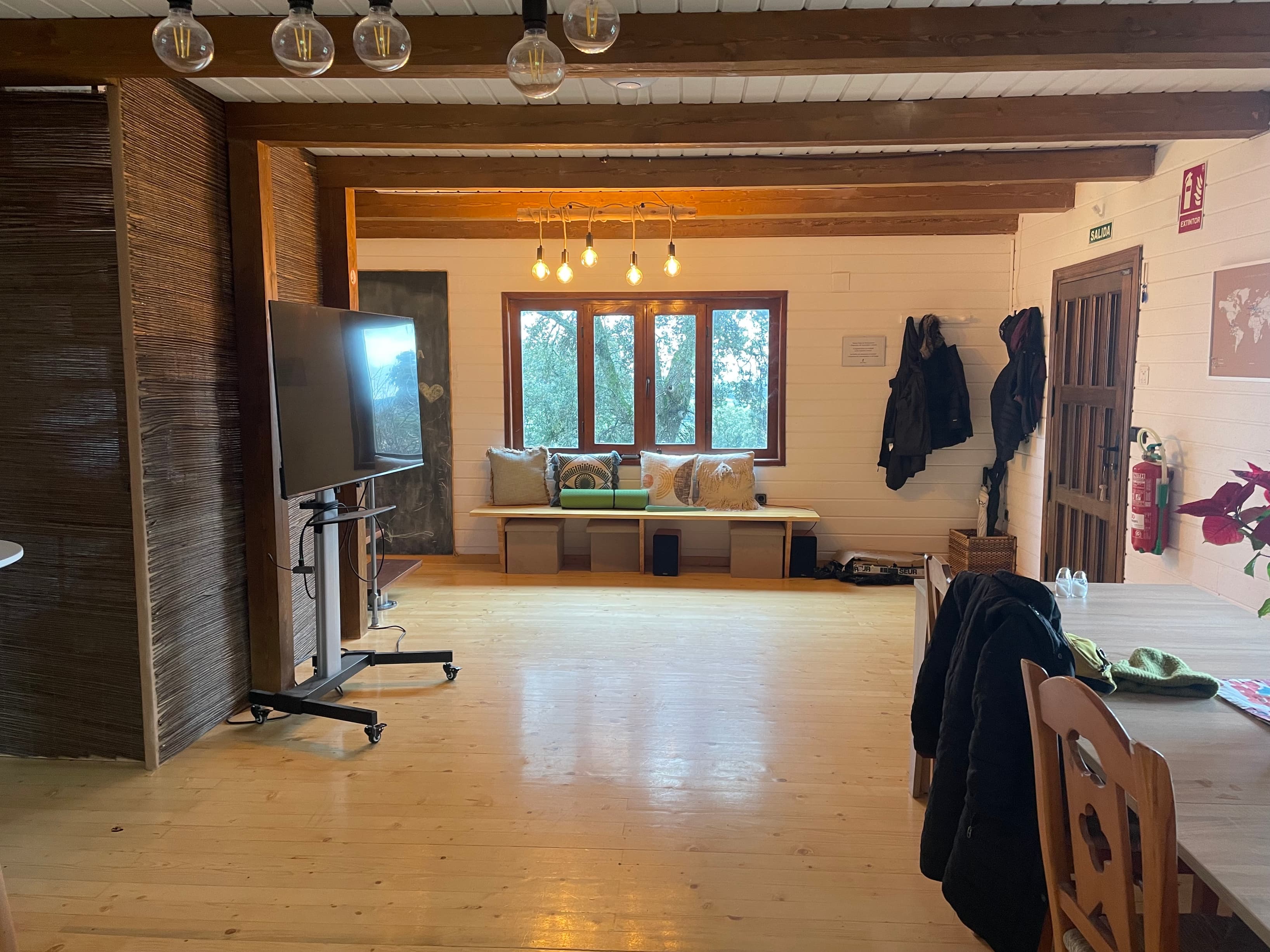 common coliving spaces, including a communal kitchen, reading room, yoga and meditation room, games room