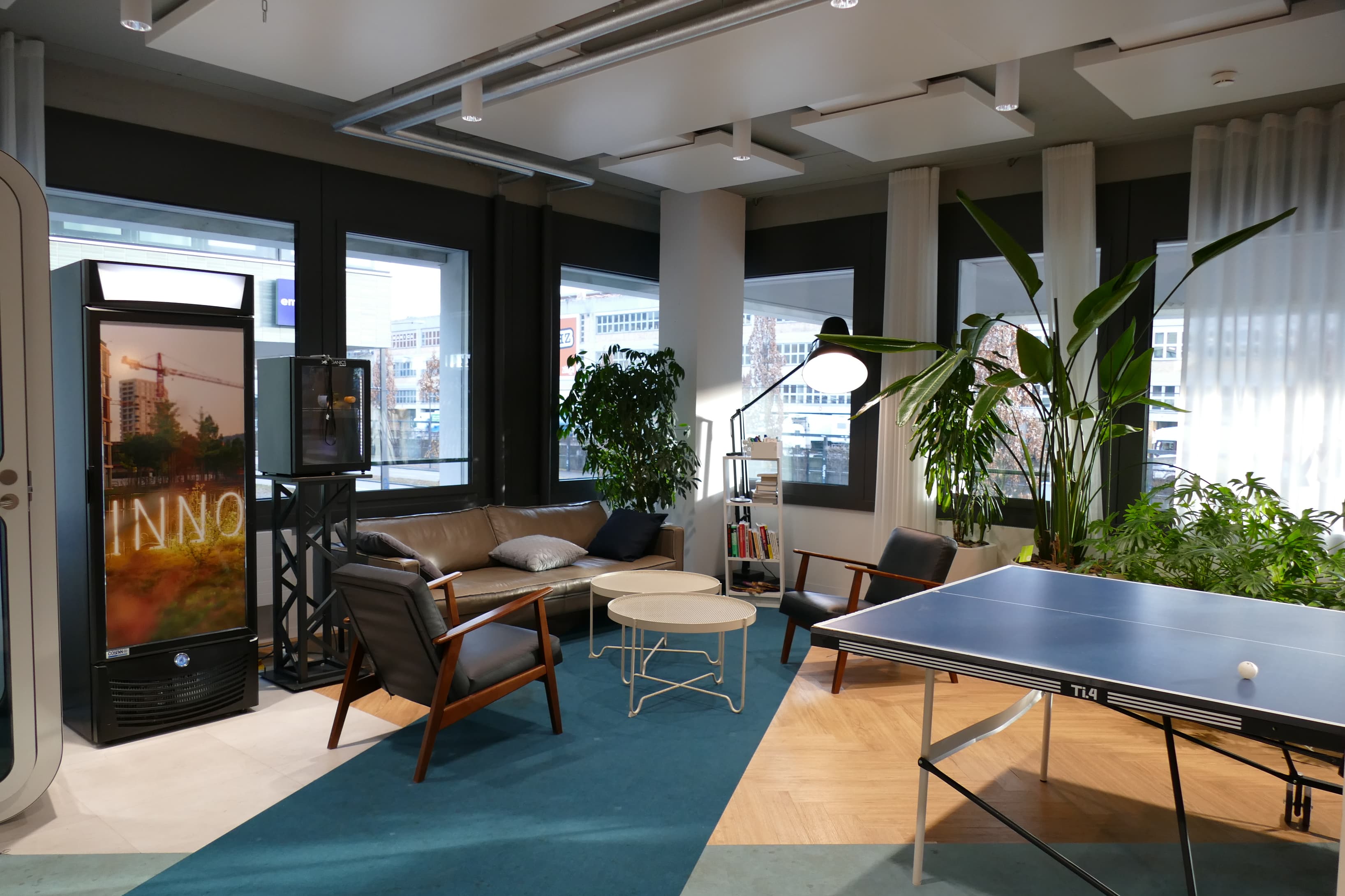 Comfortable lounge space featuring seating areas and a ping pong table.