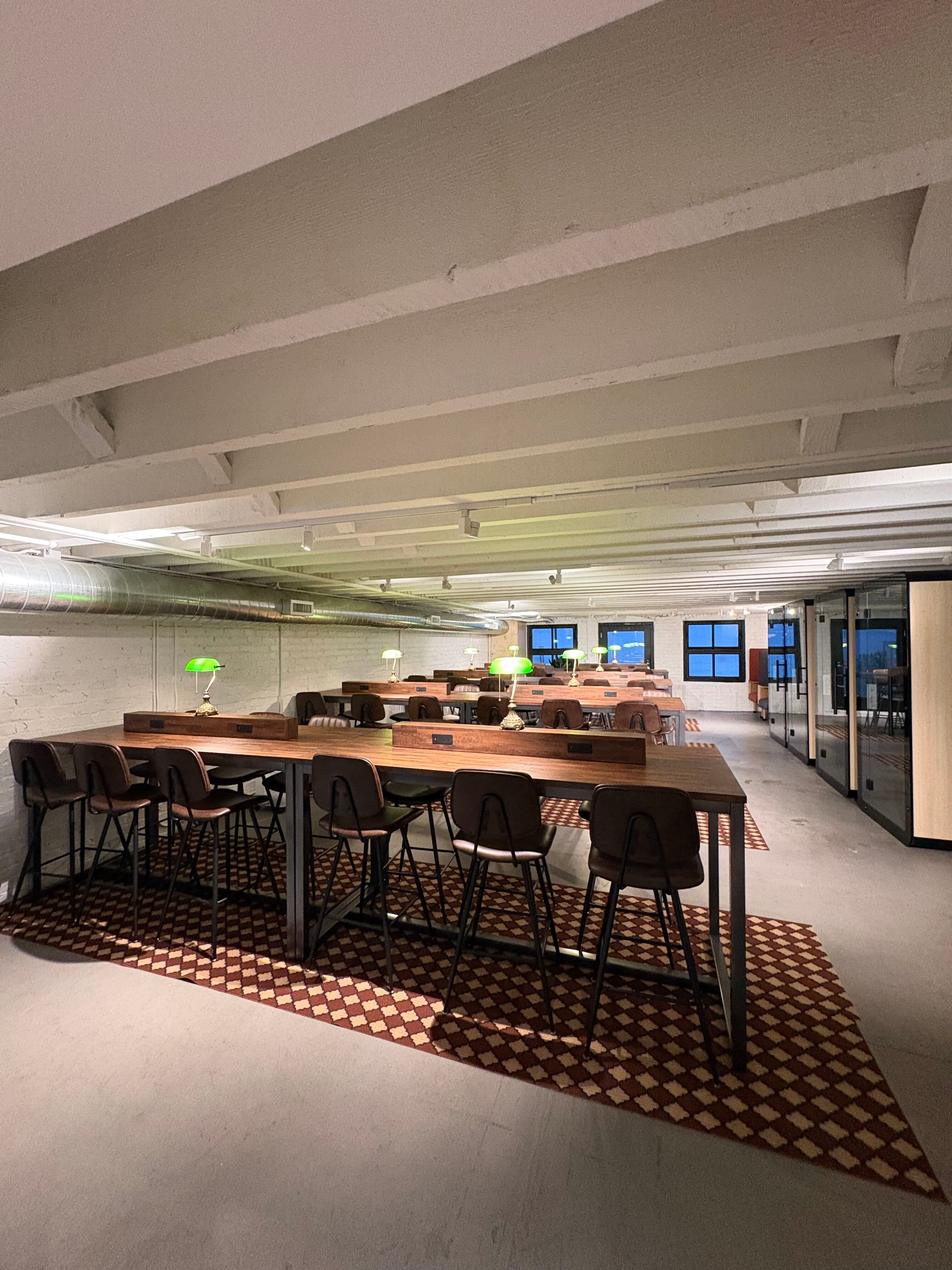 Expansive space with abundant windows and flexible meeting zones. Built for brainstorming, team gatherings, and casual collab