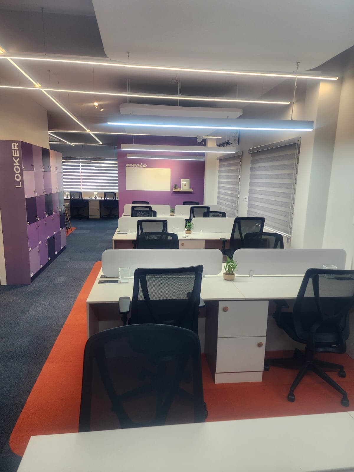 Spacious open seating area with comfortable desks, ideal for freelancers and collaborative work.