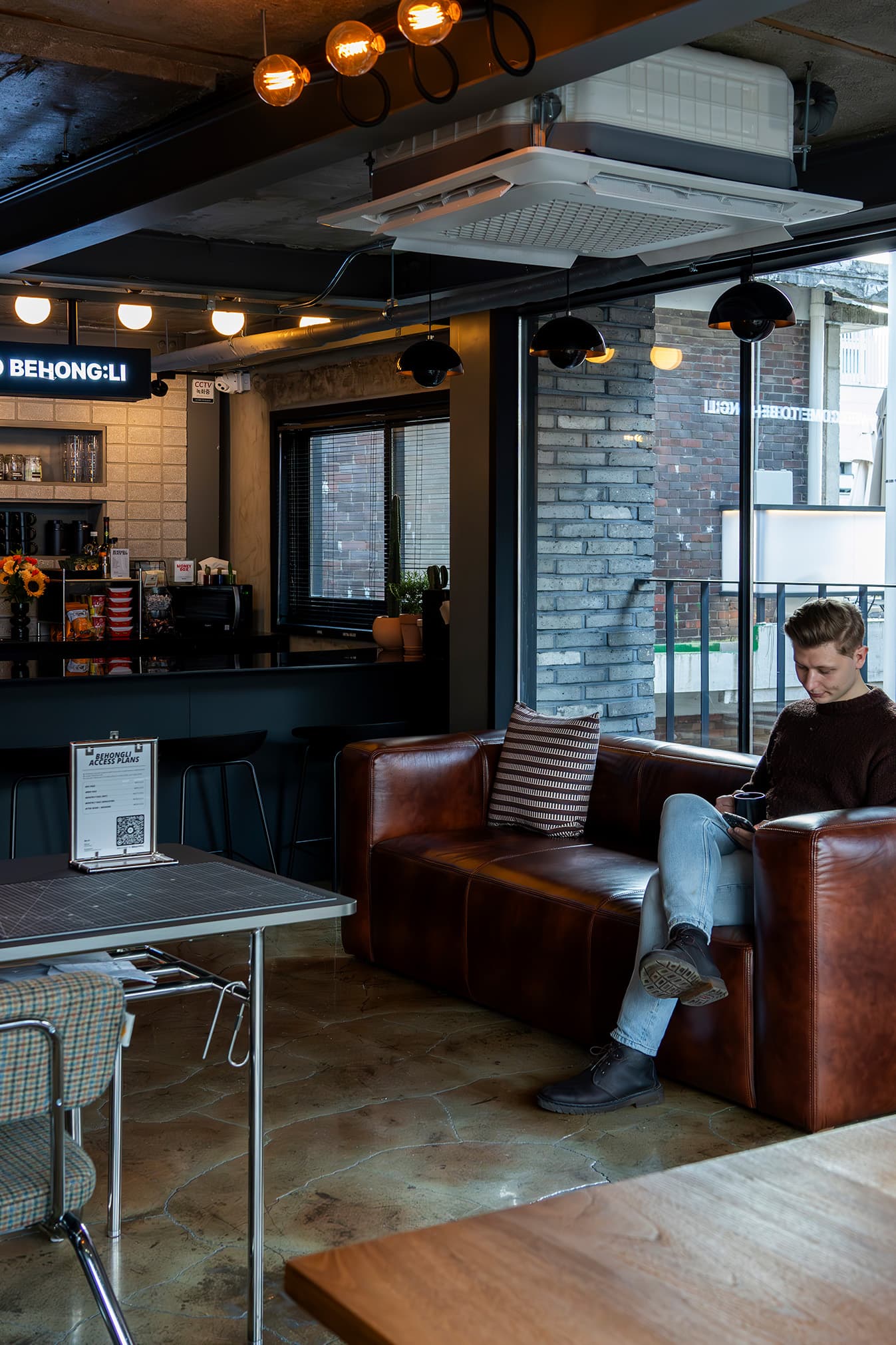 Contemporary lounge with cozy leather seating and natural light. Contemporary lounge with cozy leather seating and natural light.