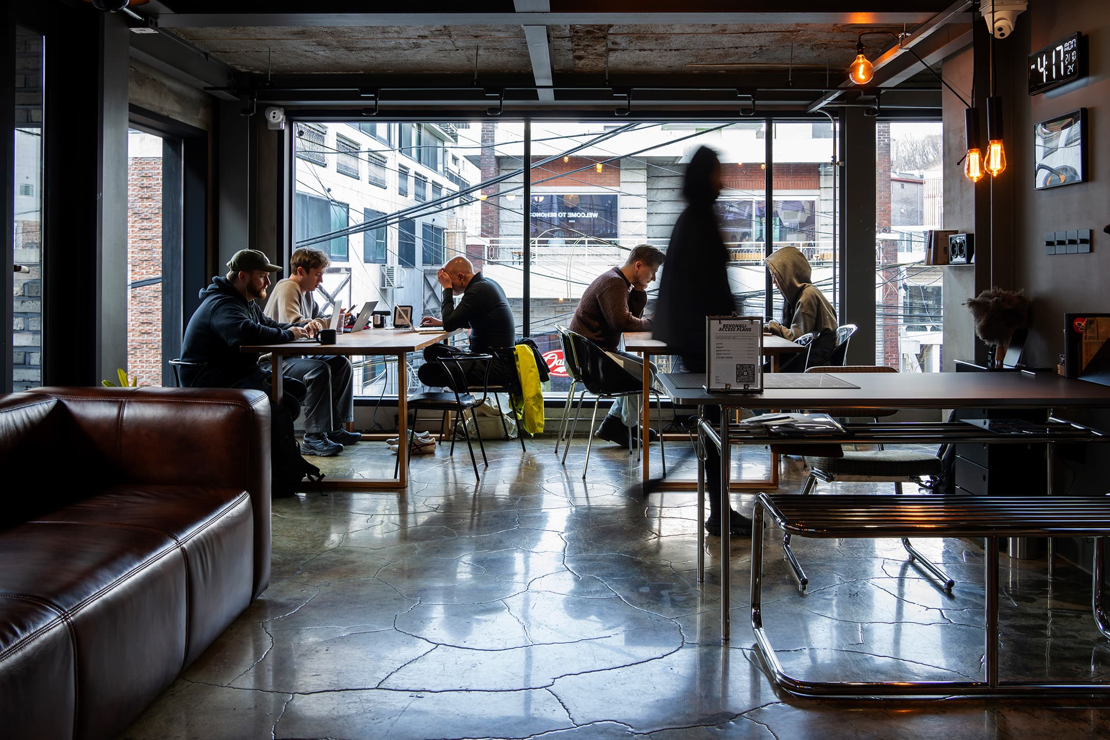 A design-forward lounge with street-level views and soft ambiance. A design-forward lounge with street-level views and soft ambiance.