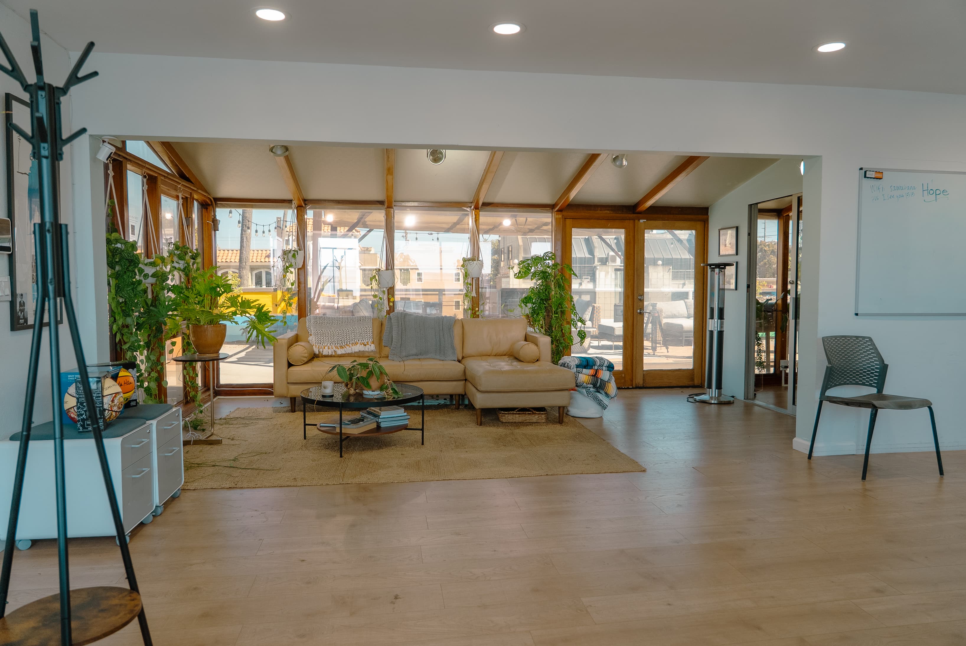 Bright and open co-working area with natural light, comfortable seating, and a clean, modern layout designed for productivity