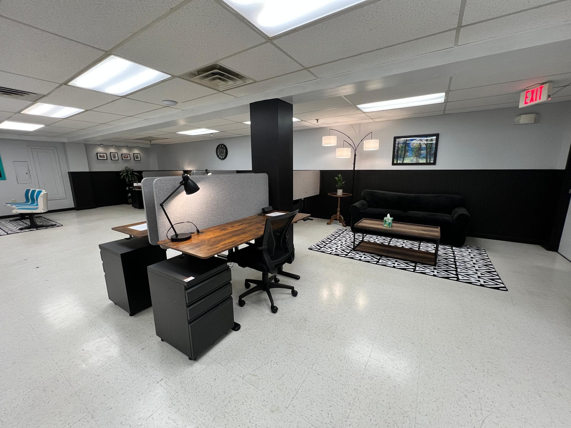 Slope Space main workspace with live-edge desks, privacy dividers, ergonomic chairs, and a lounge area with couch seating Slope Space main workspace with live-edge desks, privacy dividers, ergonomic chairs, and a lounge area with couch seating