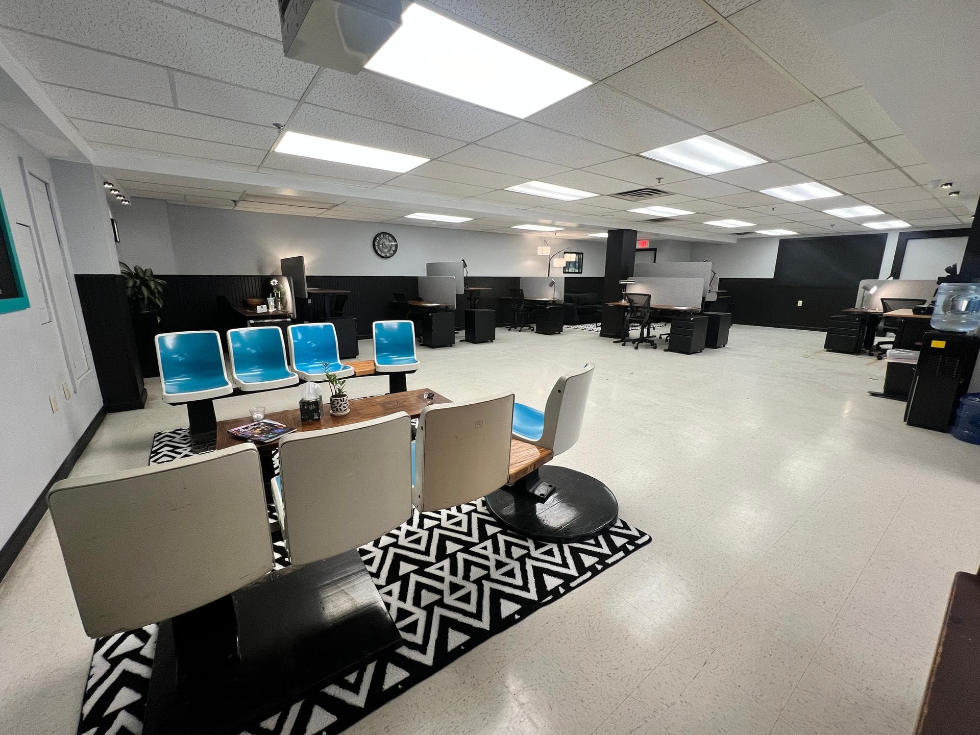 Welcome lounge and waiting area with modern seating, coffee tables, and a view into the workspace Welcome lounge and waiting area with modern seating, coffee tables, and a view into the workspace