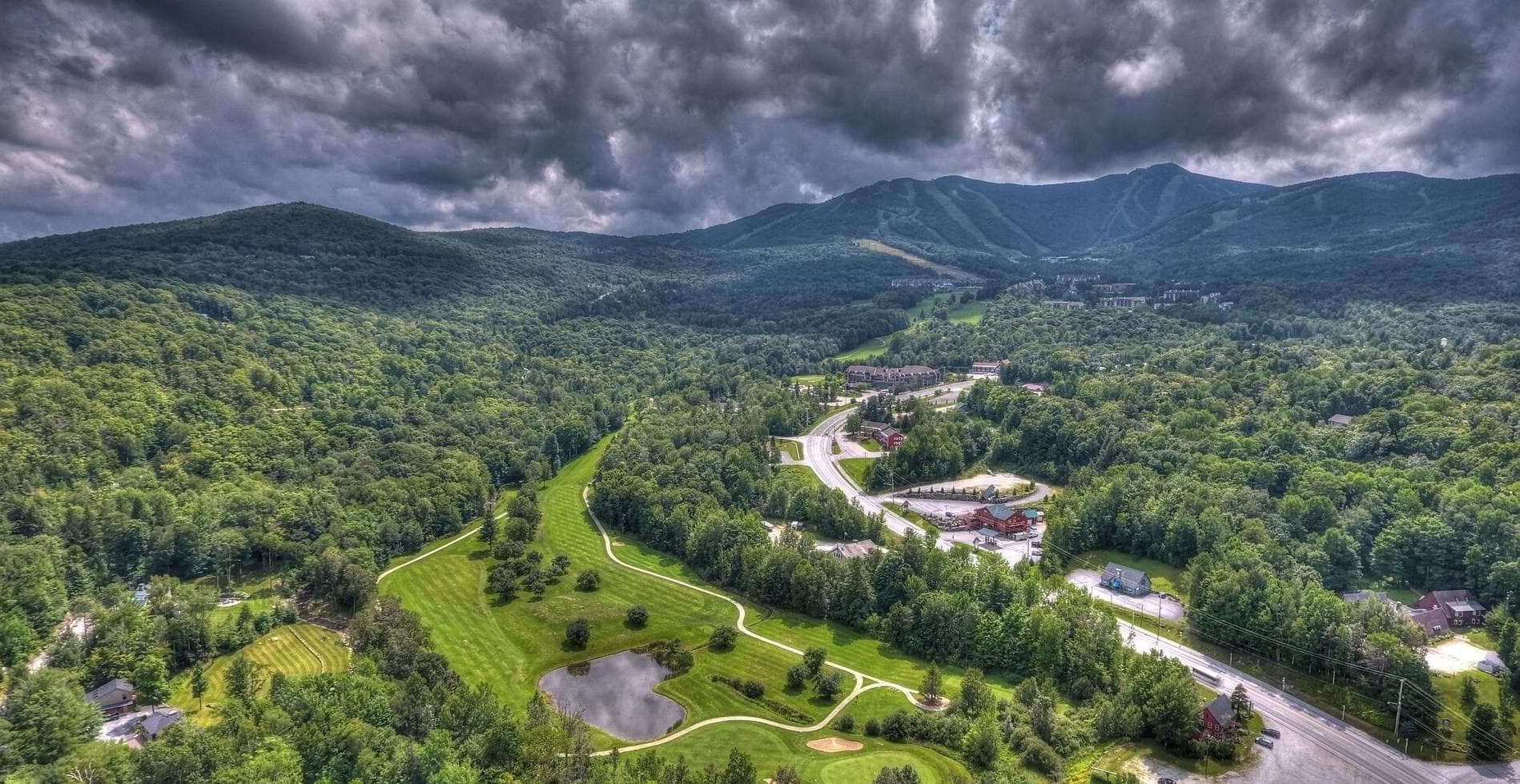 Aerial view of the Killington valley and Green Mountains from the resort, showing ski trails and the golf course Aerial view of the Killington valley and Green Mountains from the resort, showing ski trails and the golf course