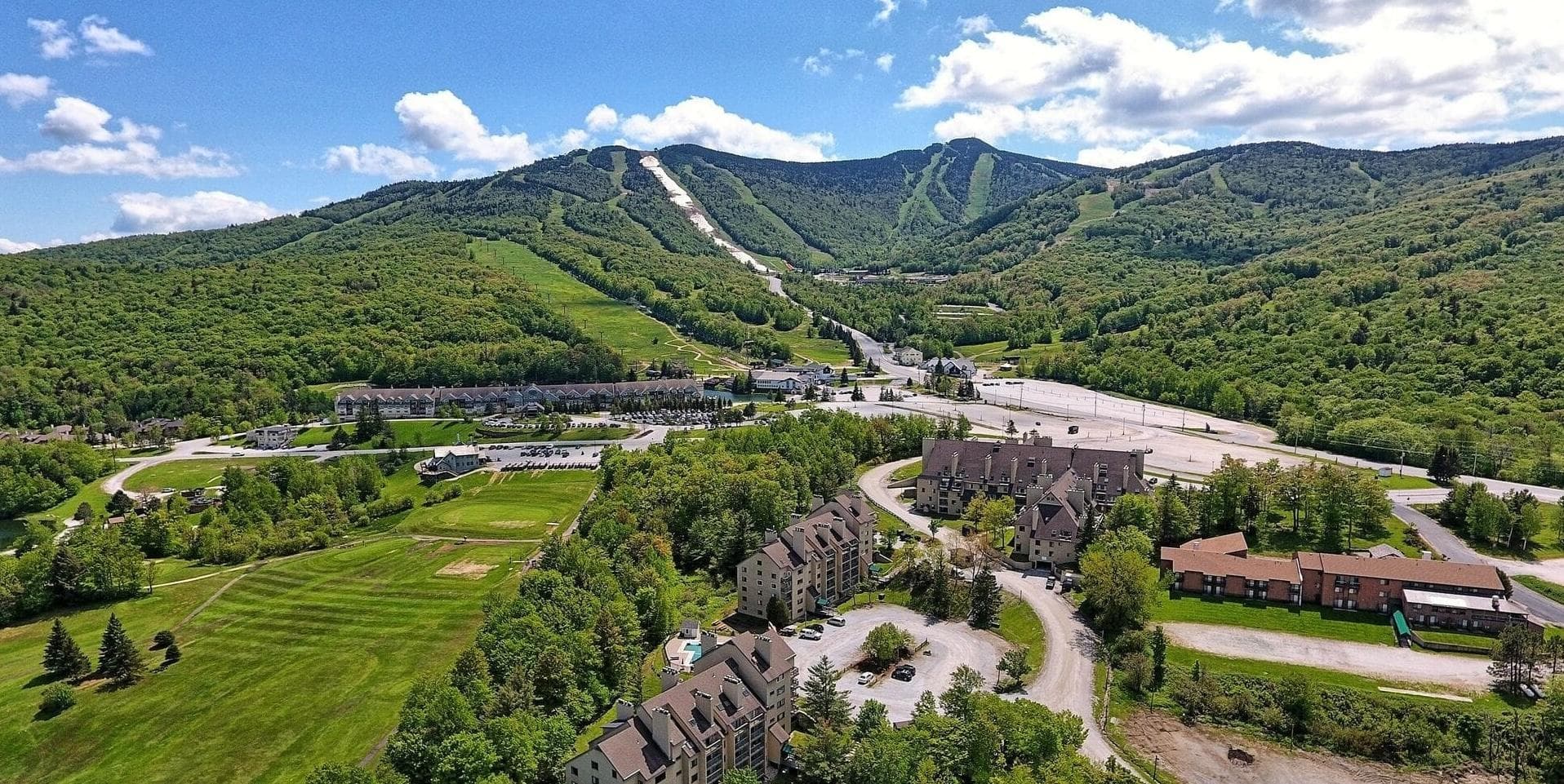 Mountain Green Resort in summer, home to Slope Space coworking, with Killington ski trails visible in the background Mountain Green Resort in summer, home to Slope Space coworking, with Killington ski trails visible in the background