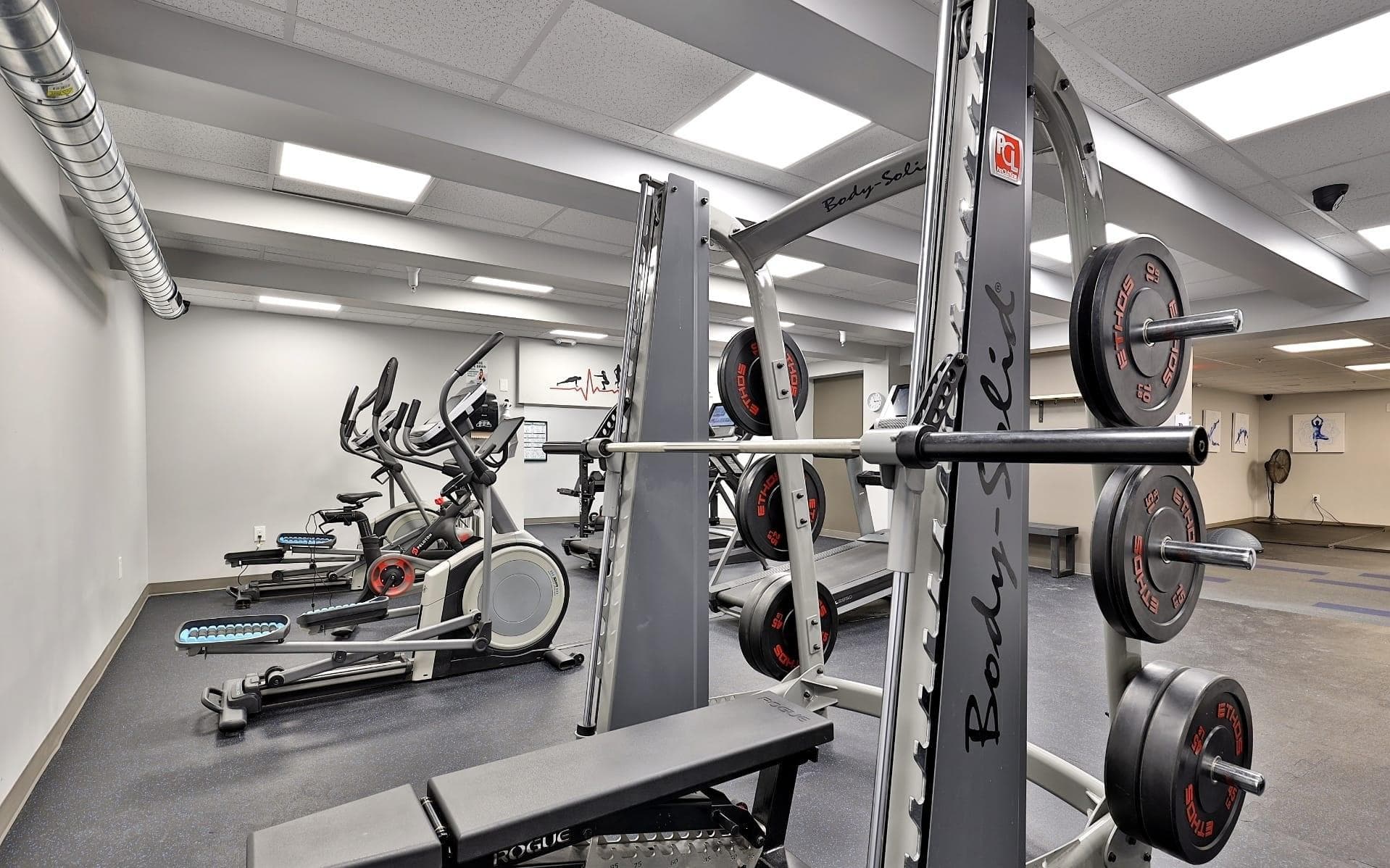 On-site fitness center with squat rack, free weights, ellipticals, and cardio machines — included with membership On-site fitness center with squat rack, free weights, ellipticals, and cardio machines — included with membership