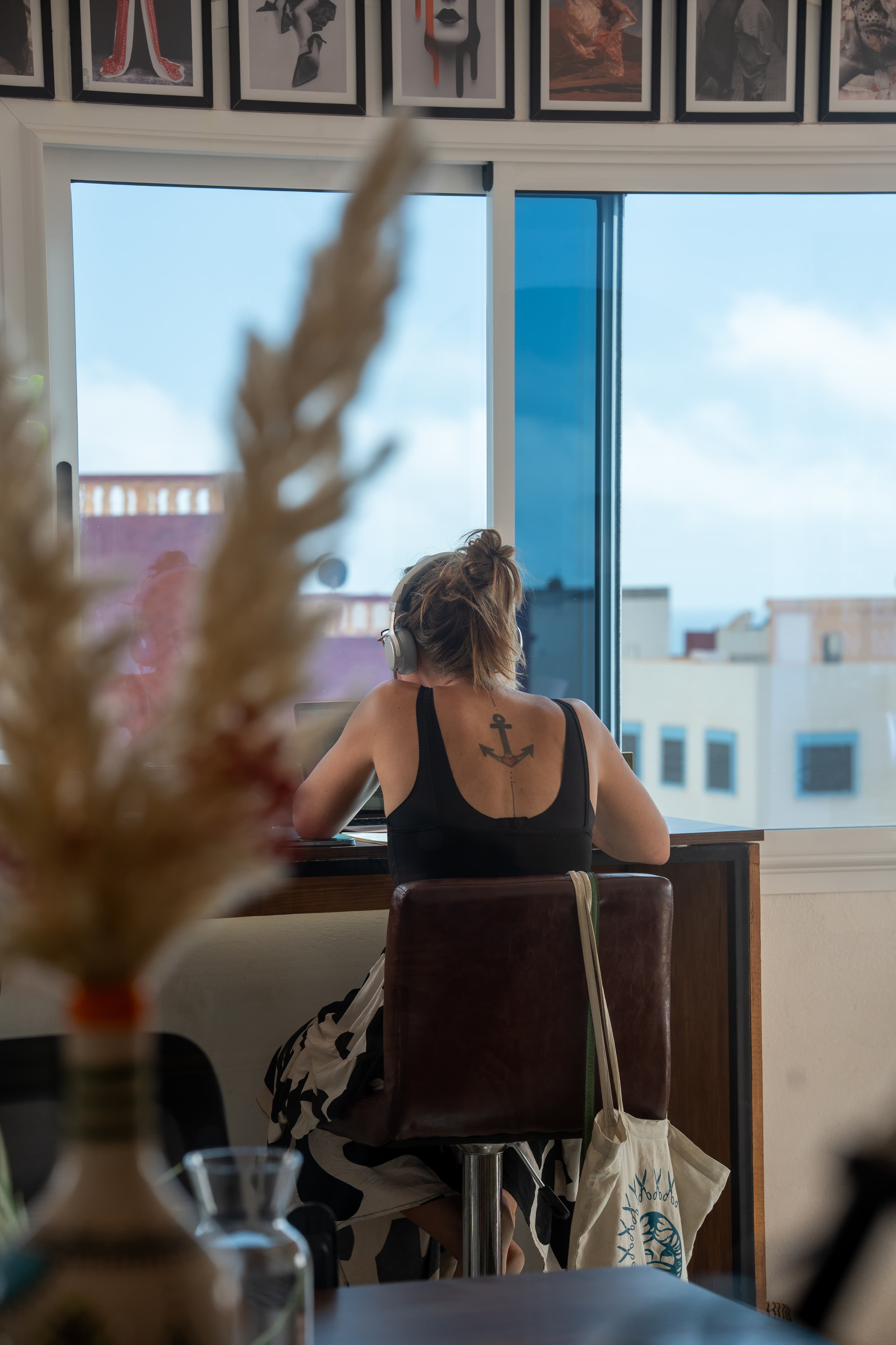 Member working at a window desk with natural light and a view over Tamraght, a setting that makes it easy to stay focused.