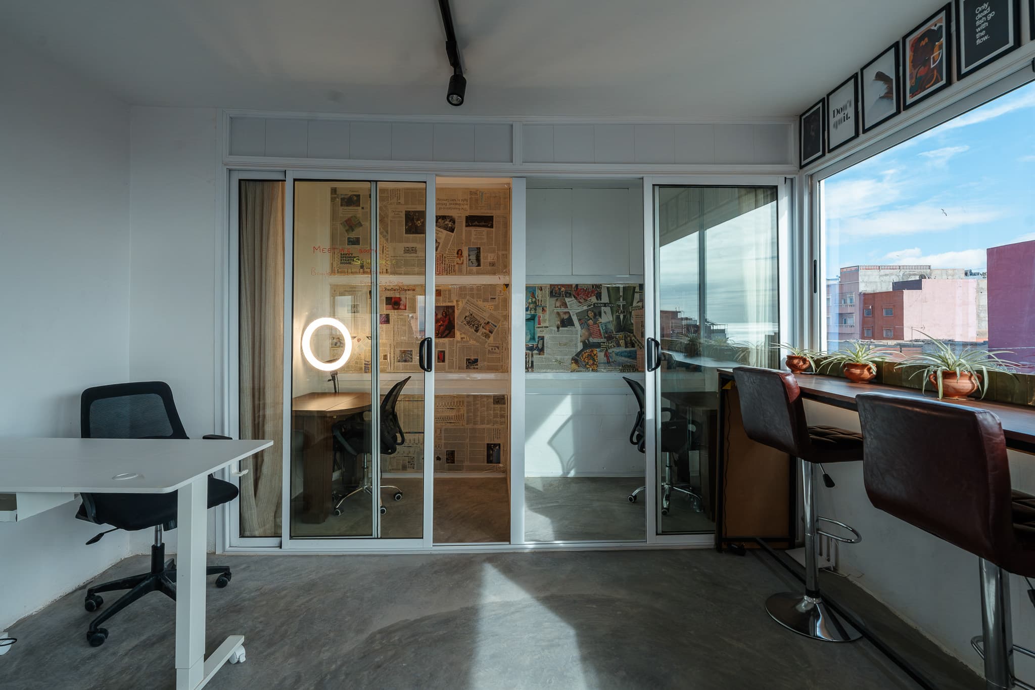 Private phone booth at Amsiln Studio, quiet space with desk, ring light, and creative walls, perfect for calls or focus