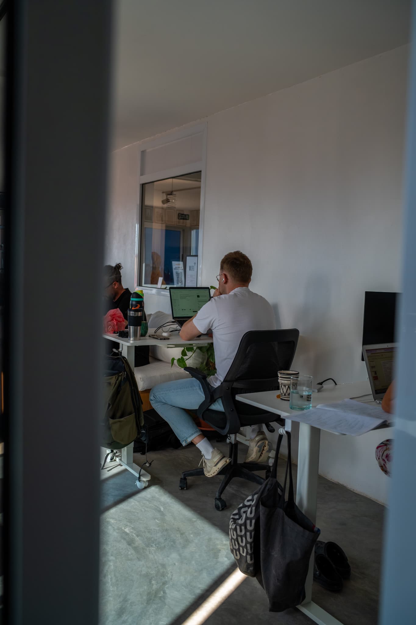 Quiet corner at Amsiln Studio with a dedicated desk, monitor, and Moroccan tea—your own office without the lease.