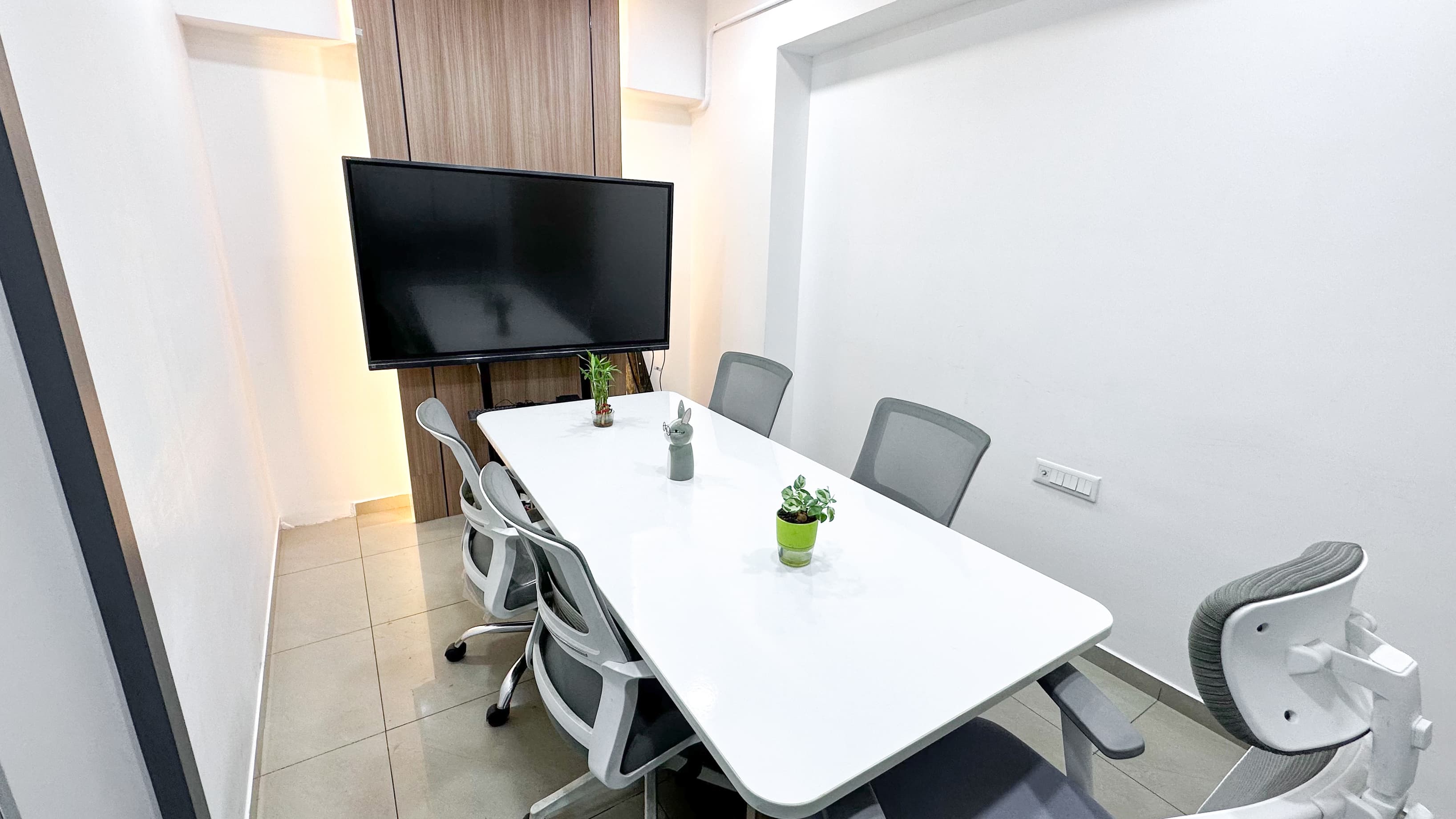 A professional meeting space designed for team discussions, client meetings, and presentations, equipped with comfortable sea