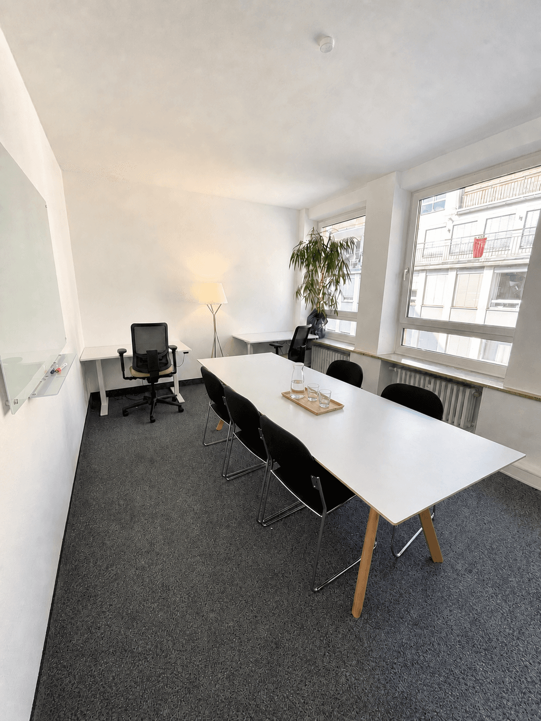 A cozy, light-filled office with a big work table, great for focused work or small sessions.