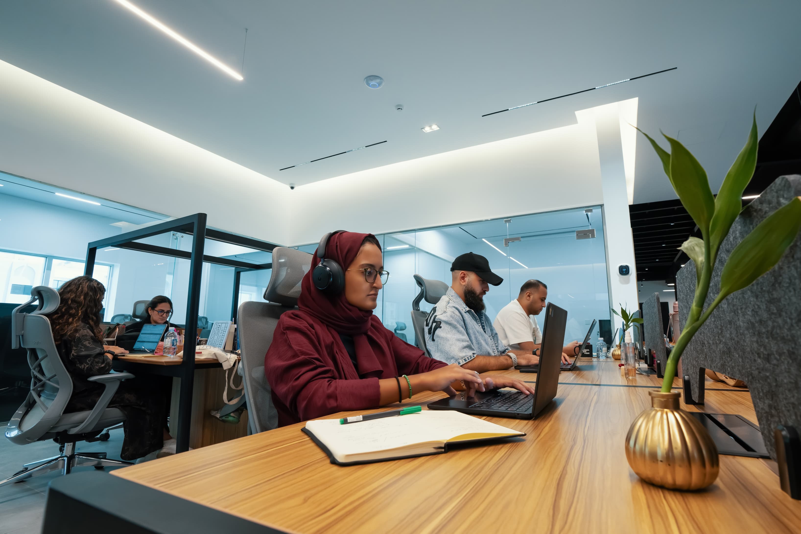 Coworking Area: An indoor image displaying people working collaboratively in a vibrant, open environment, with stylish furnit Coworking Area: An indoor image displaying people working collaboratively in a vibrant, open environment, with stylish furnit