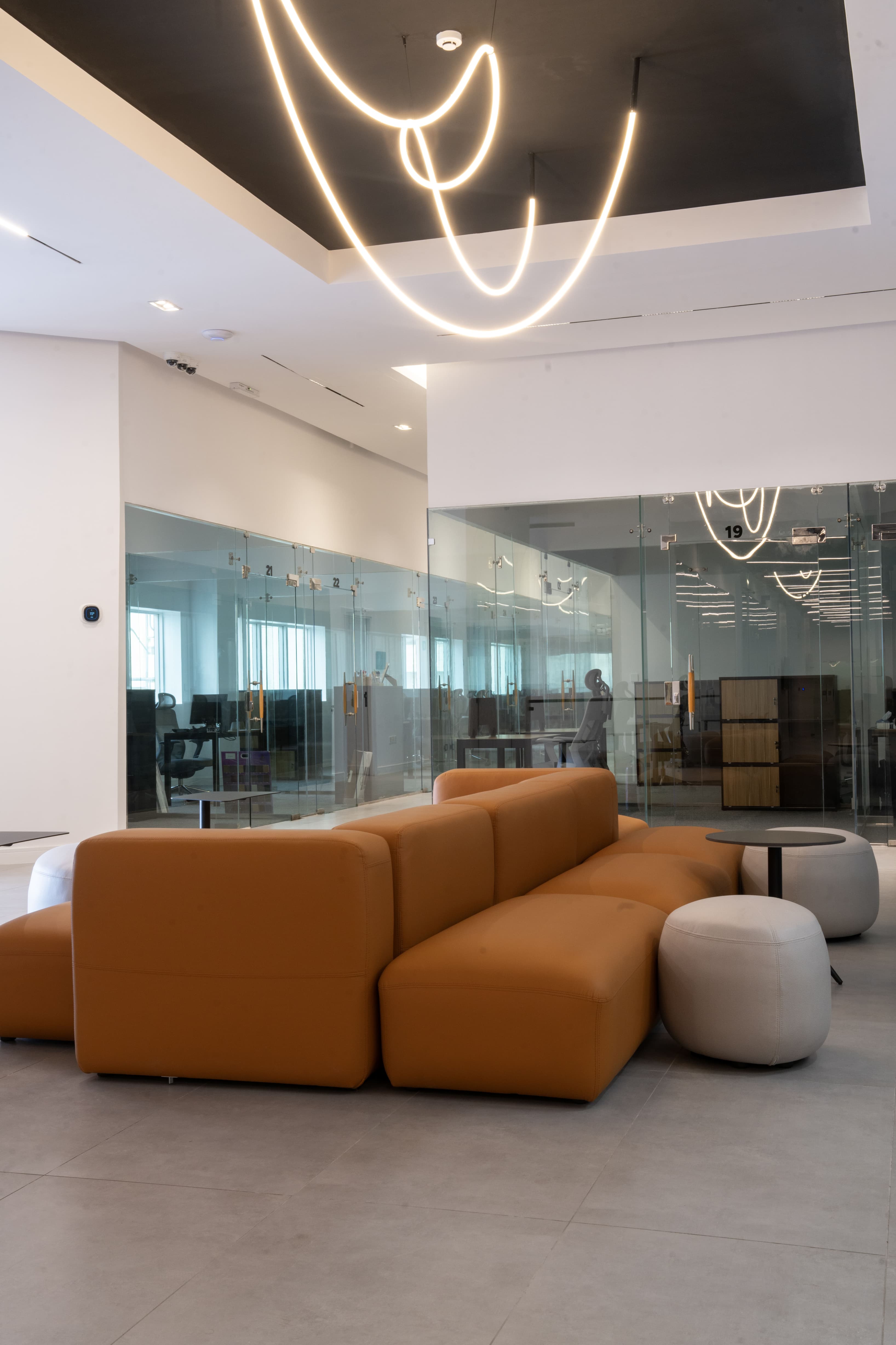 Lounge Area: A cozy seating area featuring plush, brown furniture arranged in an inviting configuration, with soft lighting t Lounge Area: A cozy seating area featuring plush, brown furniture arranged in an inviting configuration, with soft lighting t