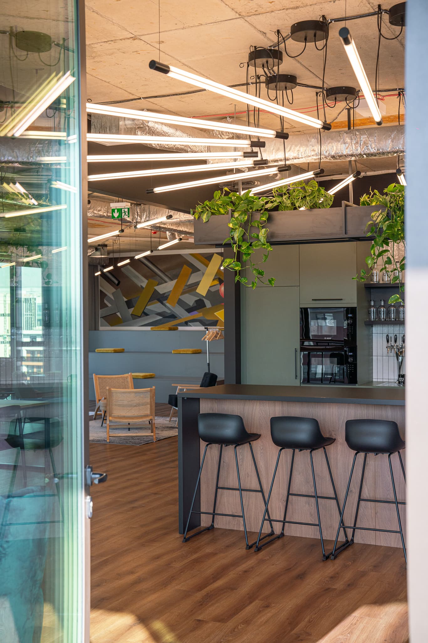A view from the outdoor terrace towards the kitchen and social zone
