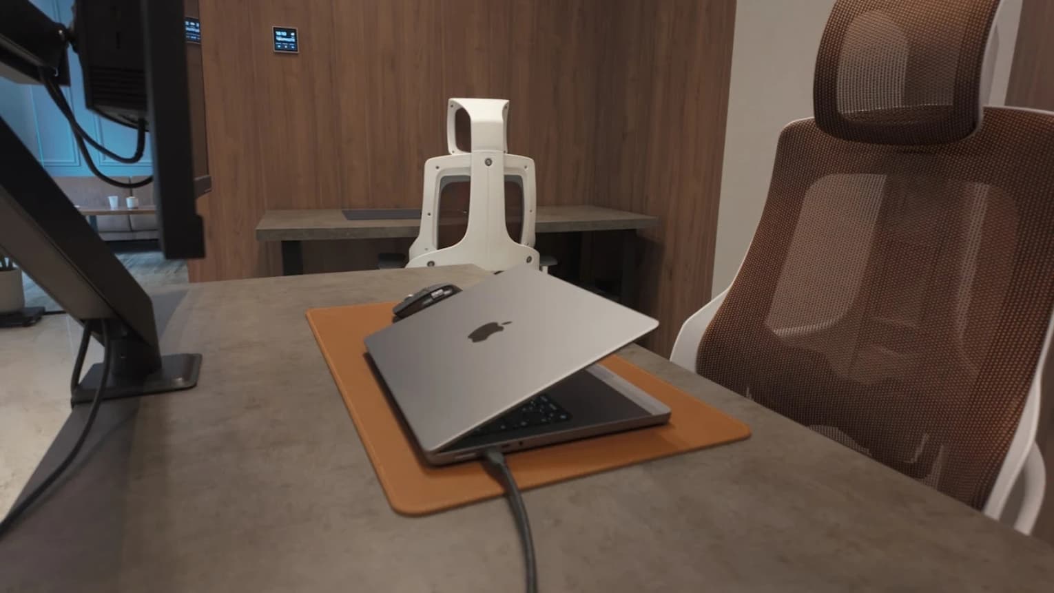 Ergonomic workstation with laptop and monitor arm on a modern desk