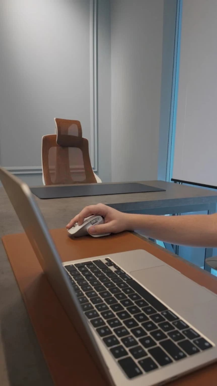 Close-up of a member using a laptop at a coworking desk