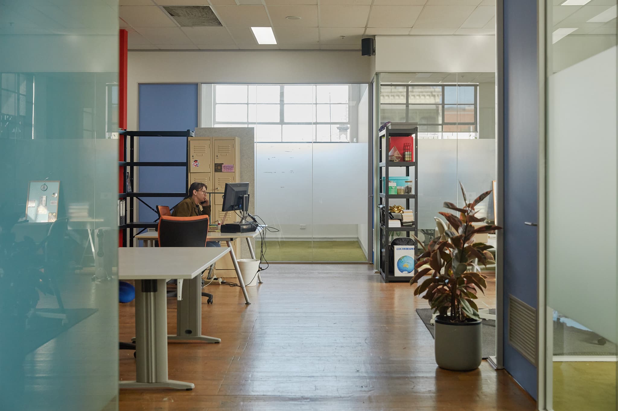 Open co-work are surrounded by private offices