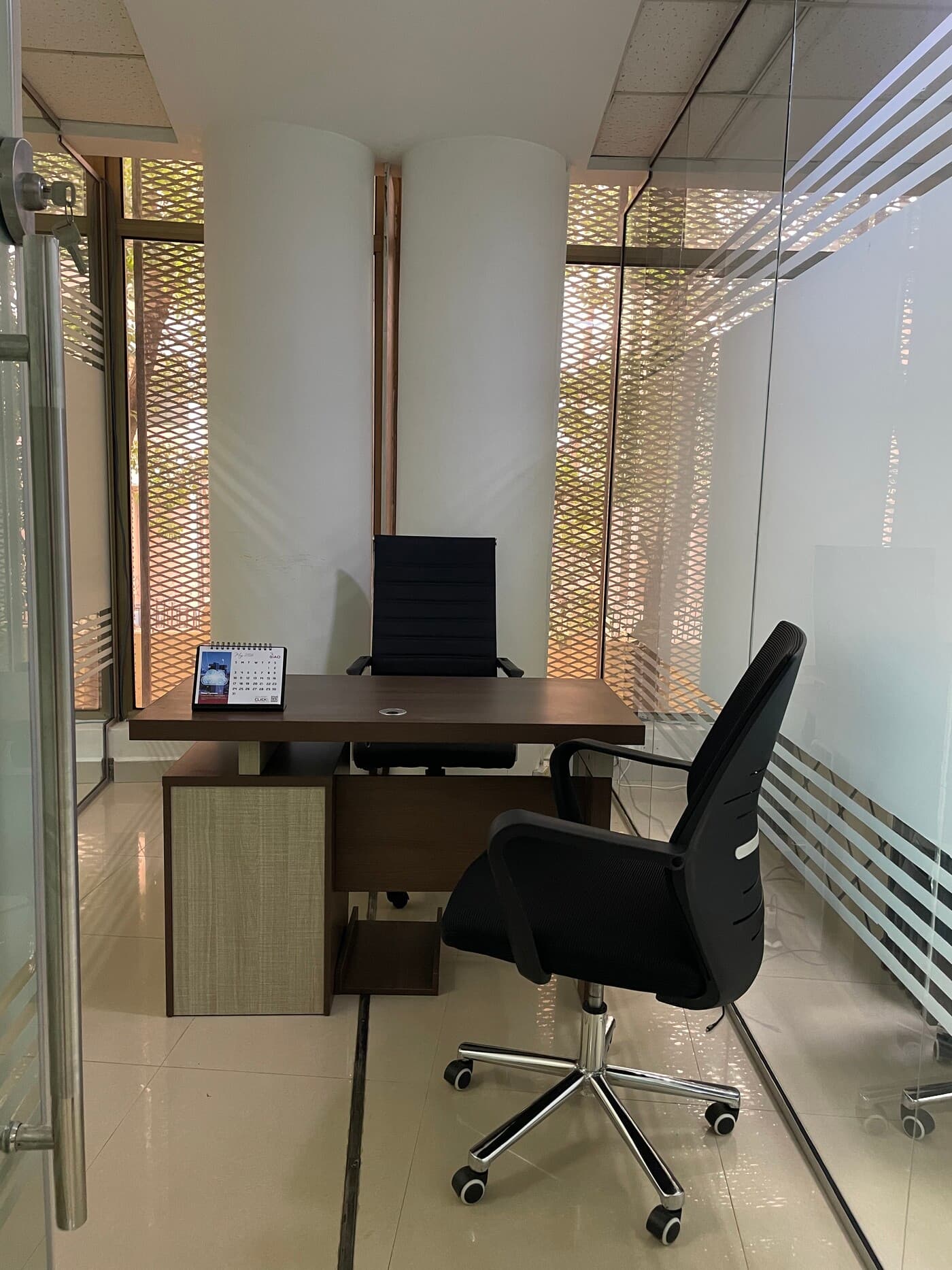 Private office with natural light, furnished workspace featuring modern desk, executive seating, floor-to-ceiling glass walls Private office with natural light, furnished workspace featuring modern desk, executive seating, floor-to-ceiling glass walls