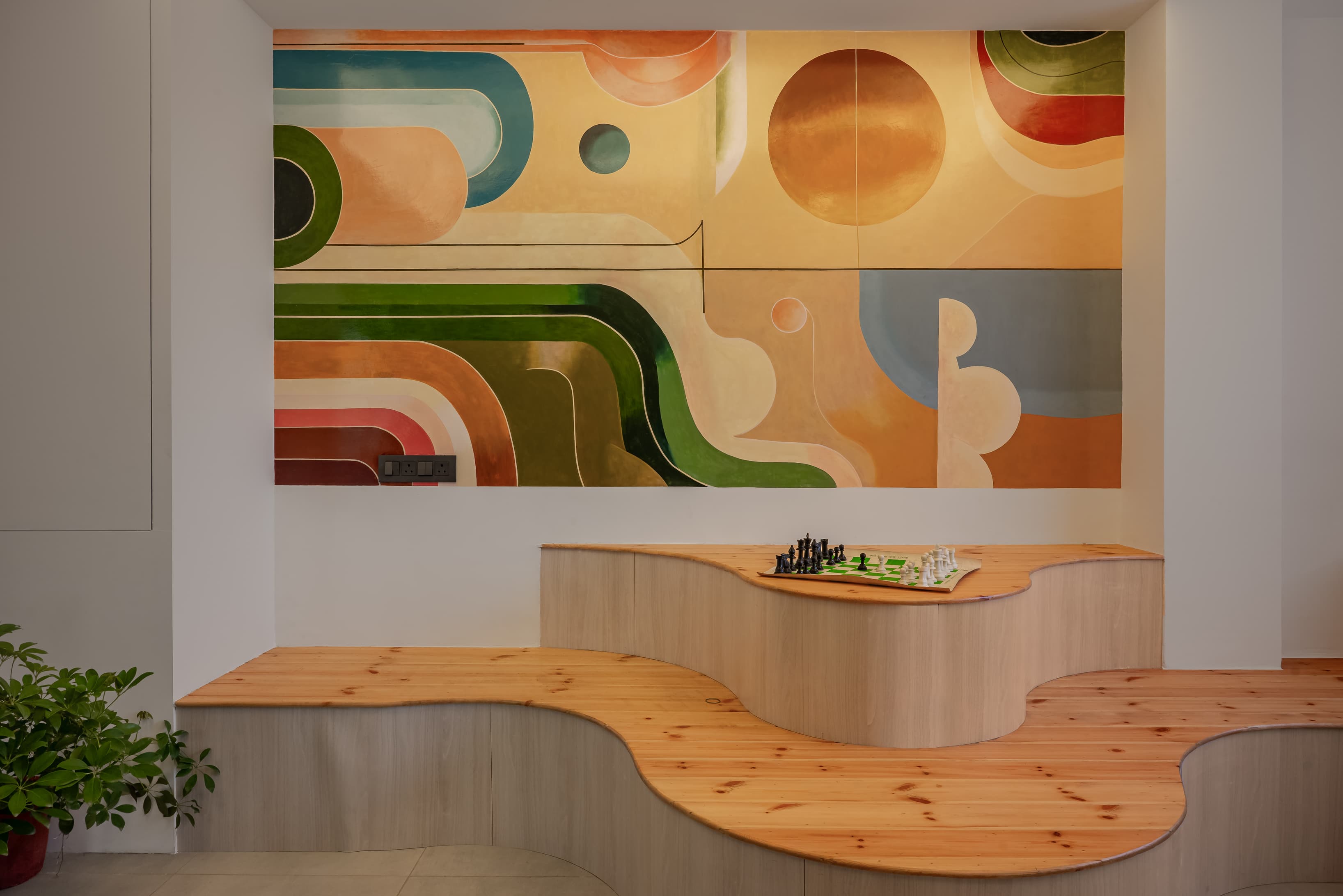 A versatile lounge cum pantry blending cozy seating with compact kitchenette for relaxed breaks.