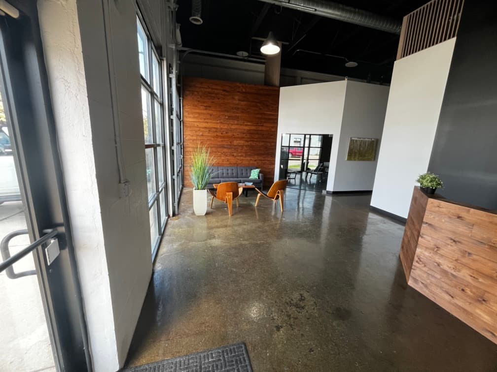 Entry point from front door. Waiting room. Hallway to back plus glass doors to conference room.