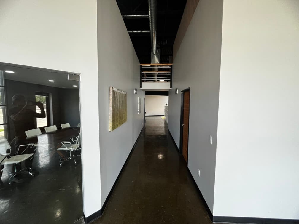 View of conference room on left and a view down the hall. Upper loft crosswalk can be seen as well. 