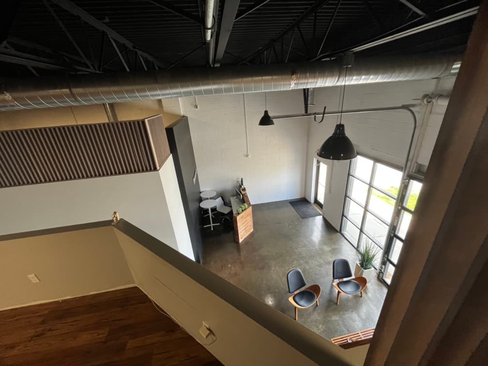 View of the back of the loft area where it overlooks waiting room and entrance. 