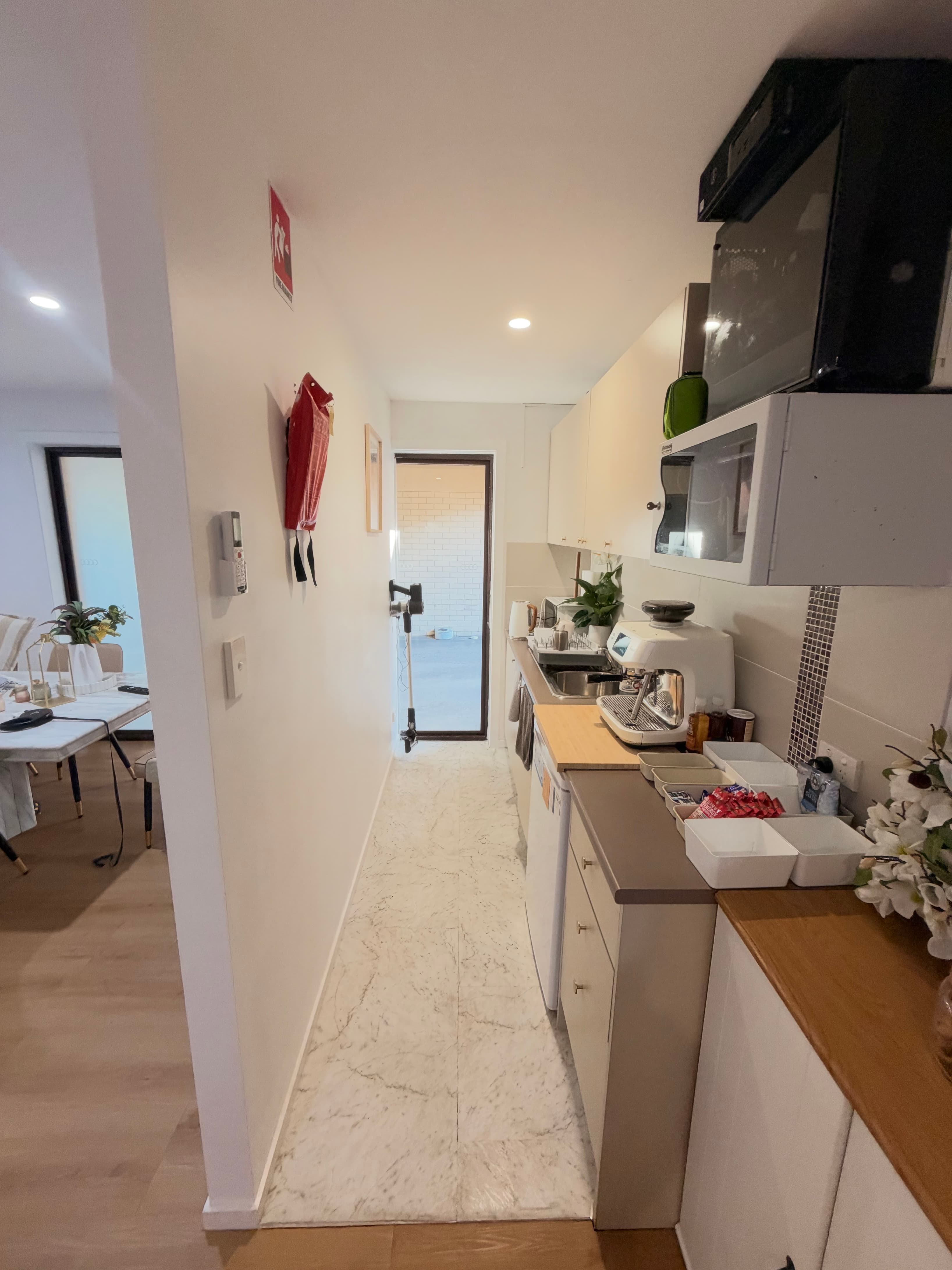 Kitchen including coffee machine, fridge and sink