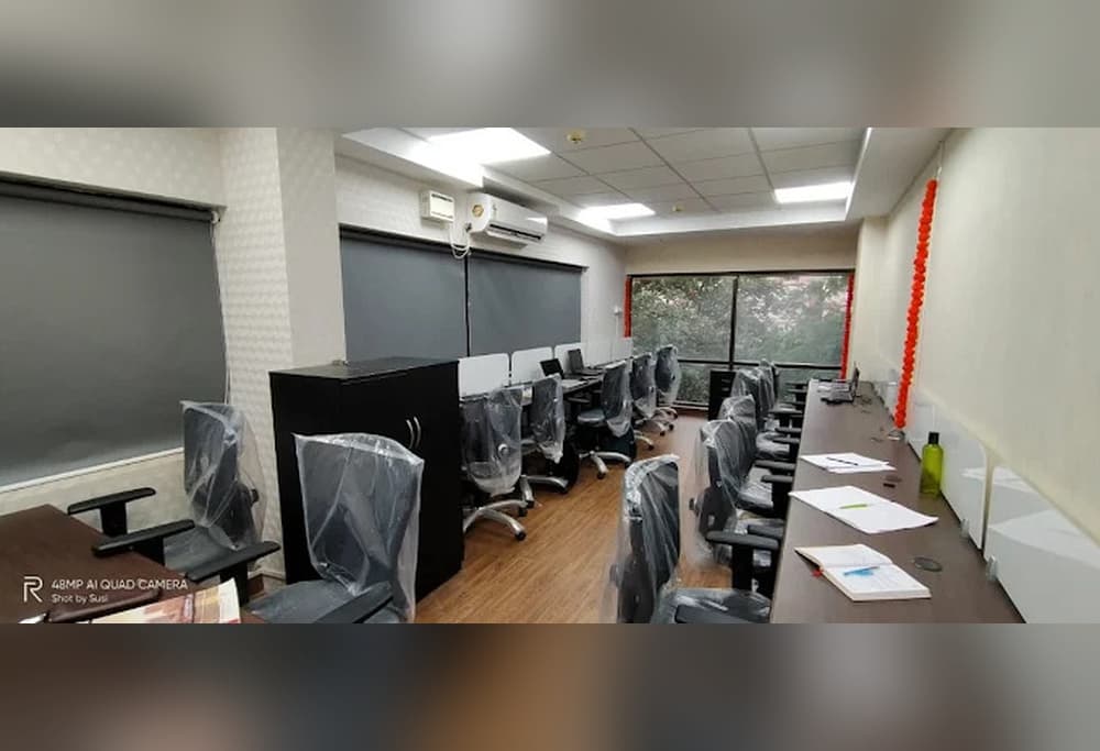 Fully furnished coworking space at Ecowrkz Coimbatore, featuring comfortable office chairs, dedicated workstations and a prof Fully furnished coworking space at Ecowrkz Coimbatore, featuring comfortable office chairs, dedicated workstations and a prof