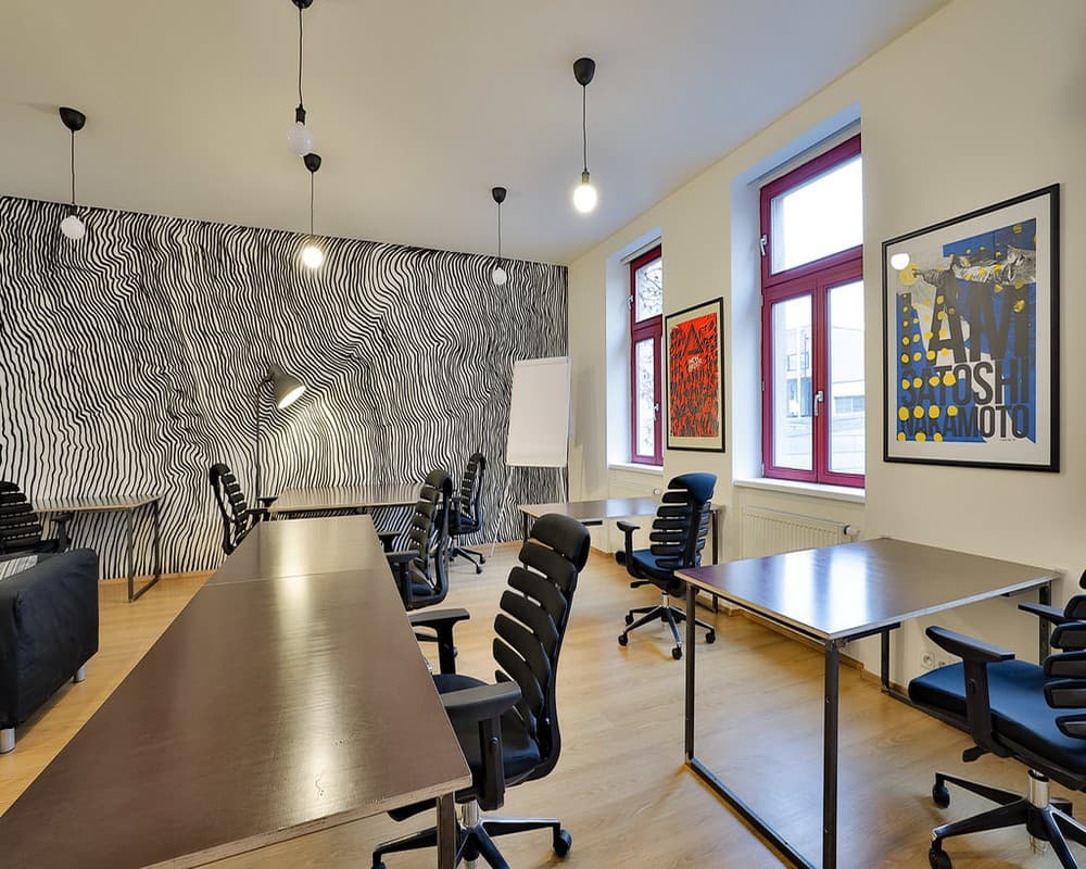 Bright open coworking area with desks, sofas, and creative wall art — perfect for focused work or informal collaboration. Bright open coworking area with desks, sofas, and creative wall art — perfect for focused work or informal collaboration.